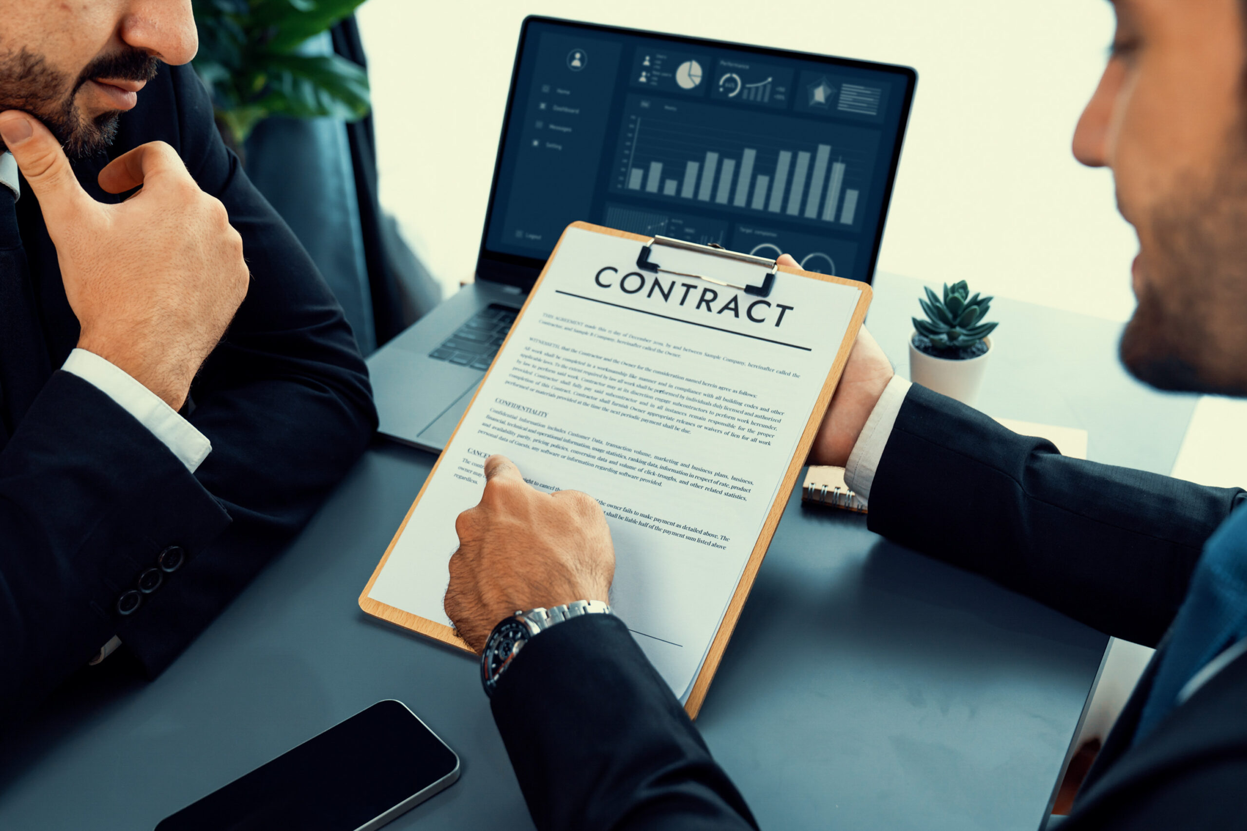 Business professionals reviewing a document using a free electronic contract signing solution, demonstrating how a contract signing tool streamlines approval processes.