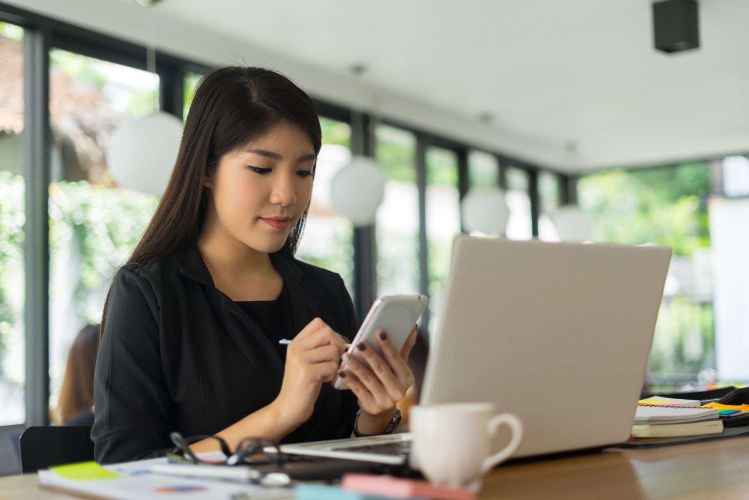 Business professional managing digital documents using eSignature platforms and a free electronic signature on mobile and laptop.