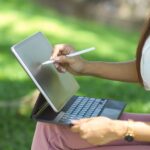 Woman using a tablet and stylus to complete a free electronic signature, illustrating the flexibility of electronic mobile sign solutions for remote work.