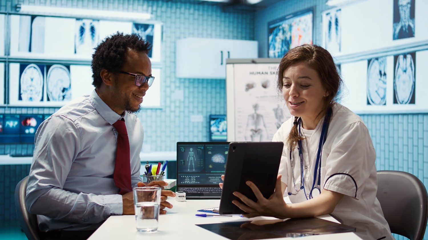 Doctor showing digital documents to a patient using Electronic Signature for Healthcare, demonstrating how esignature online free tools streamline medical approvals with the best esignature software.