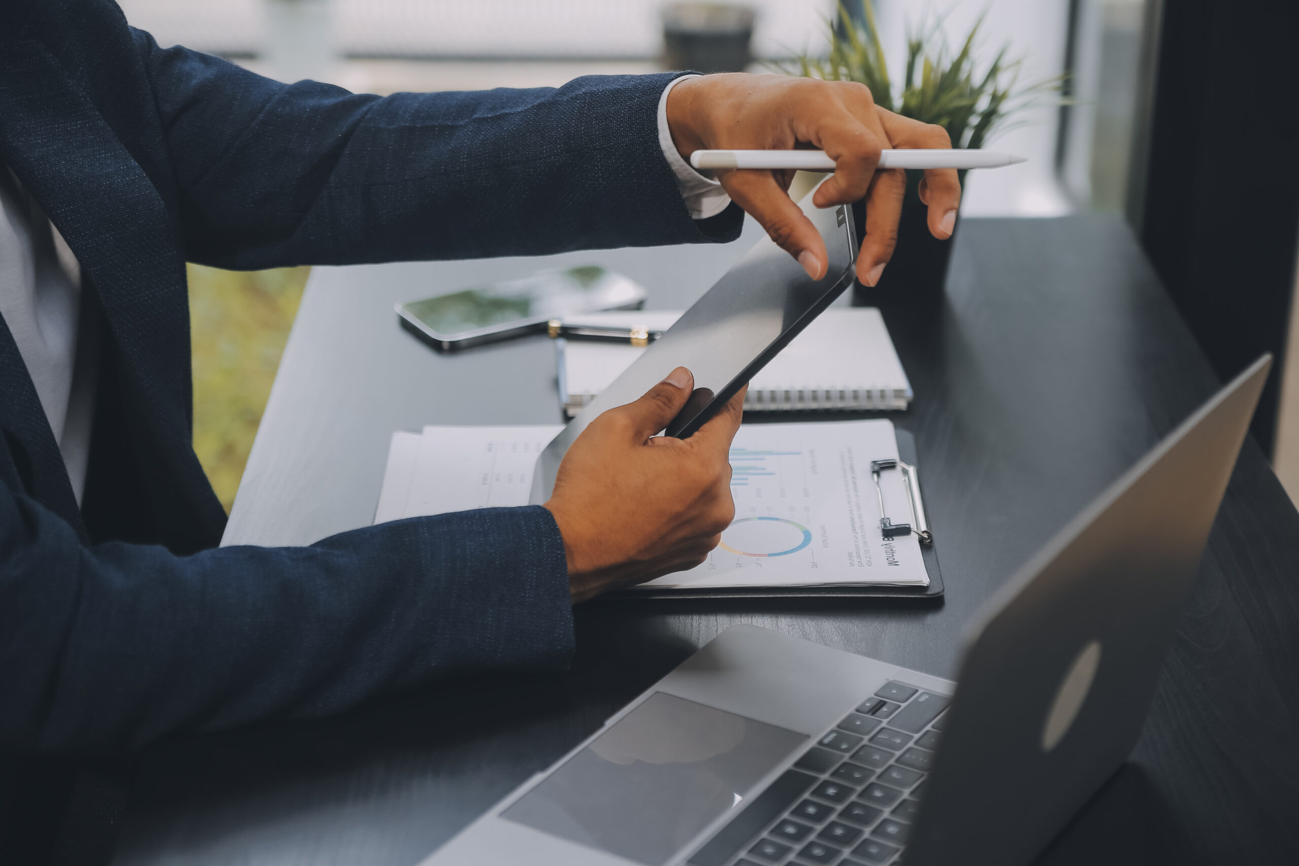 Business professional using a tablet for best e-signature service, demonstrating an electronic signature for contracts in a modern digital workspace.