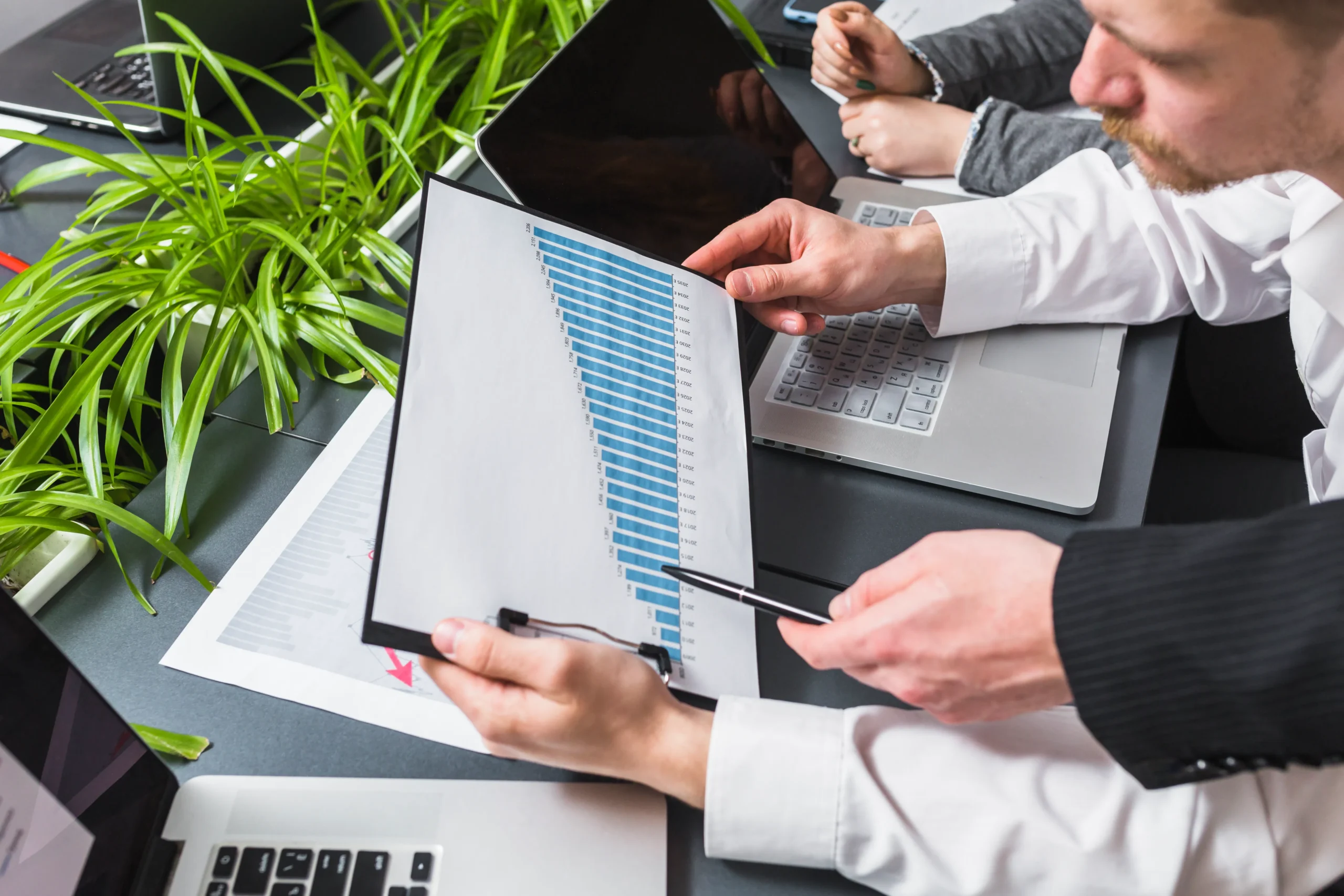 HR manager using an electronic signature app for HR onboarding with a secure digital signature app for HR onboarding on a laptop.