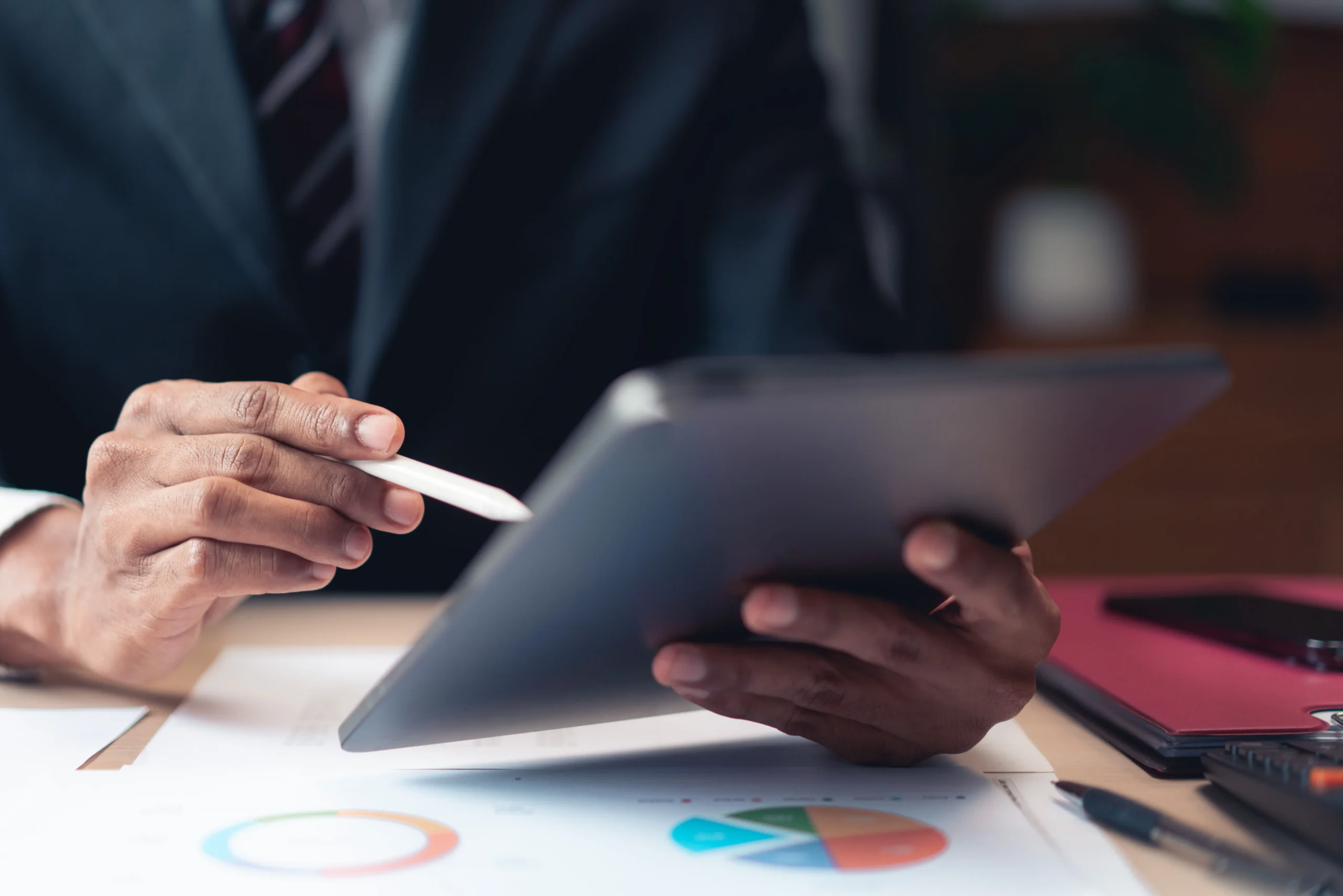 Executive using a tablet and stylus to complete sales paperwork with Electronic Signatures supported by an Esignature app for sales contracts.