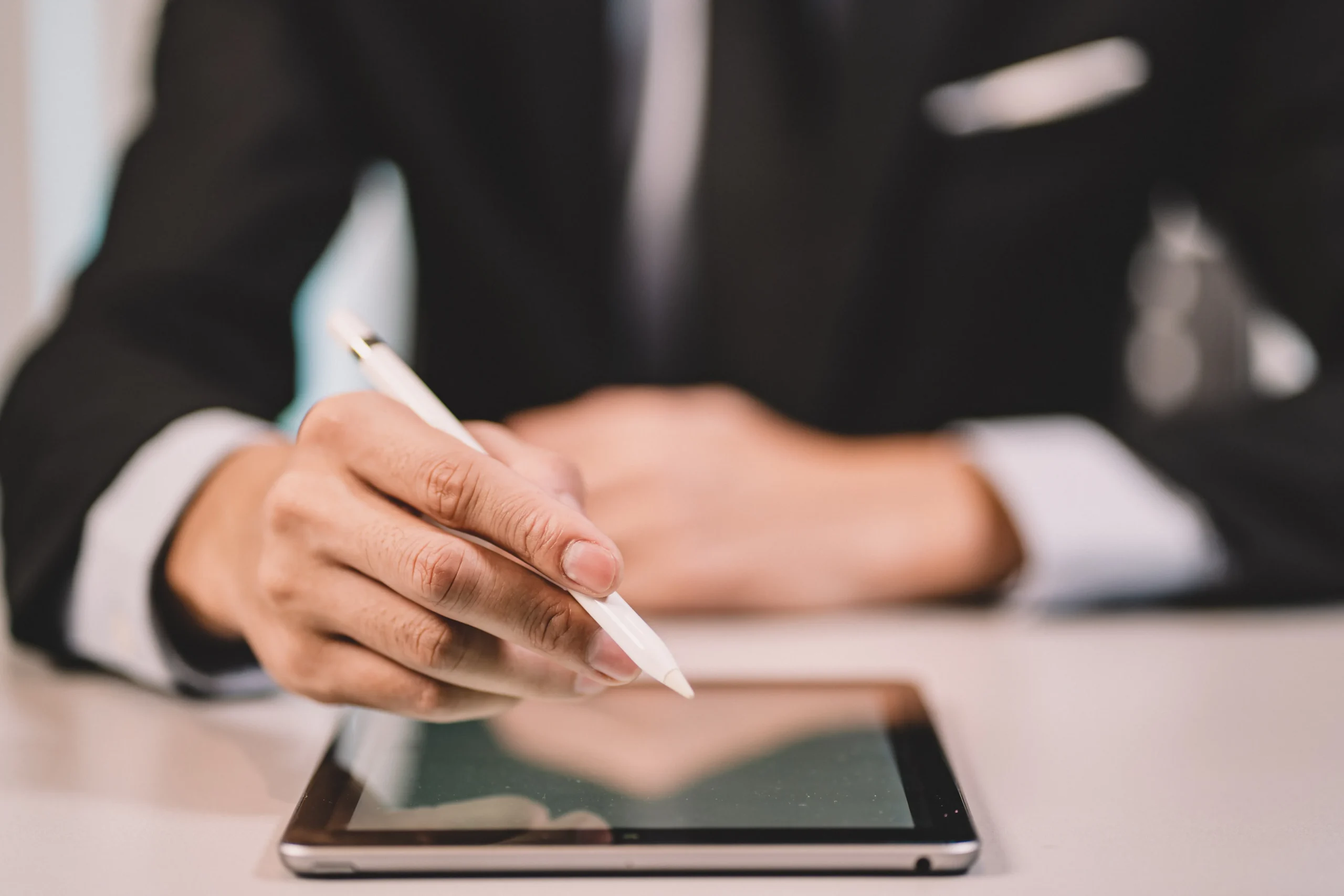 Lawyer reviewing paperwork and signing legal documents using an Electronic Signature app for Legal Contracts with a secure digital signature app for legal contracts.
