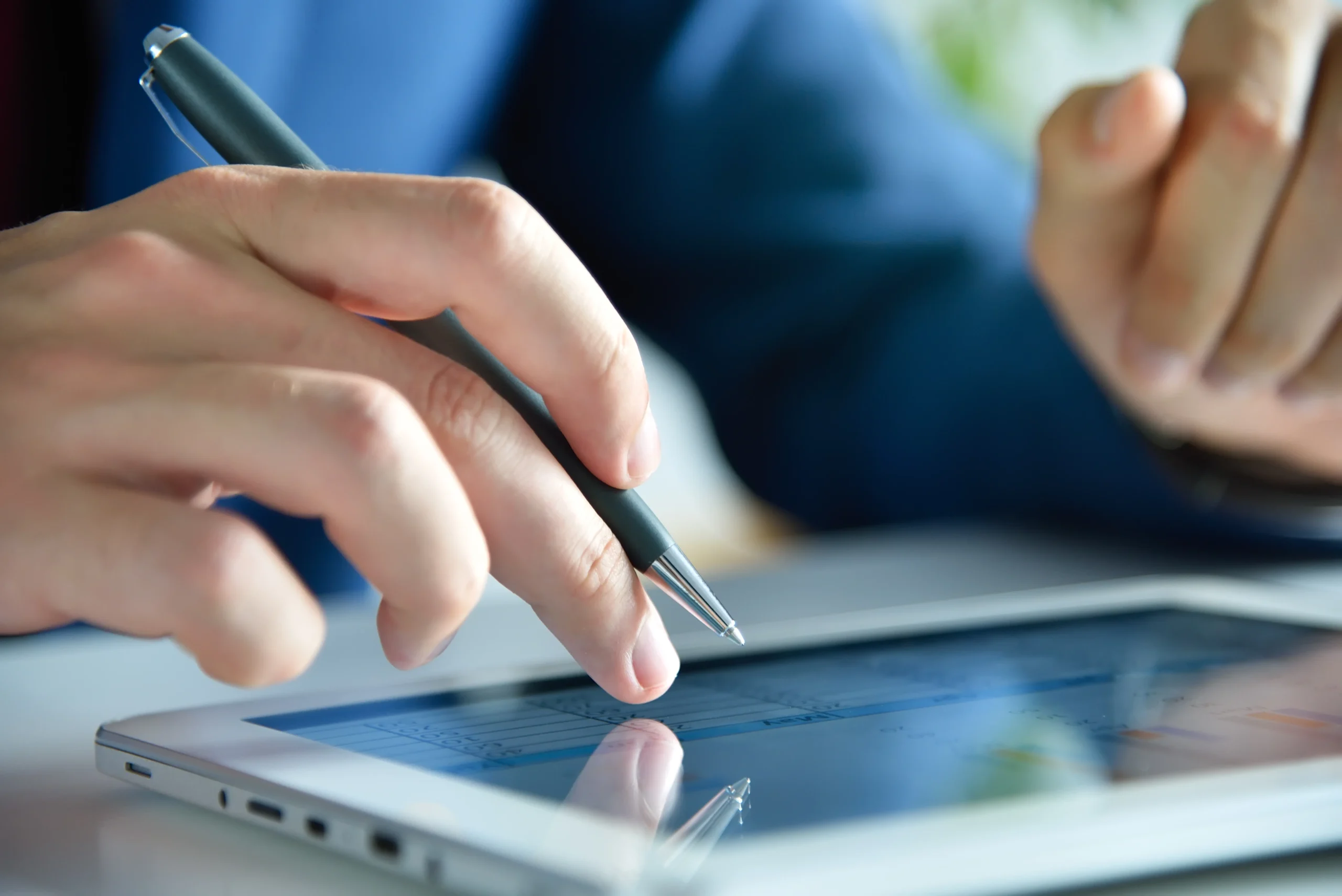 Professional using a digital tablet to apply Electronic Signatures through an Esignature app for sales contracts, ensuring fast and secure contract approvals.