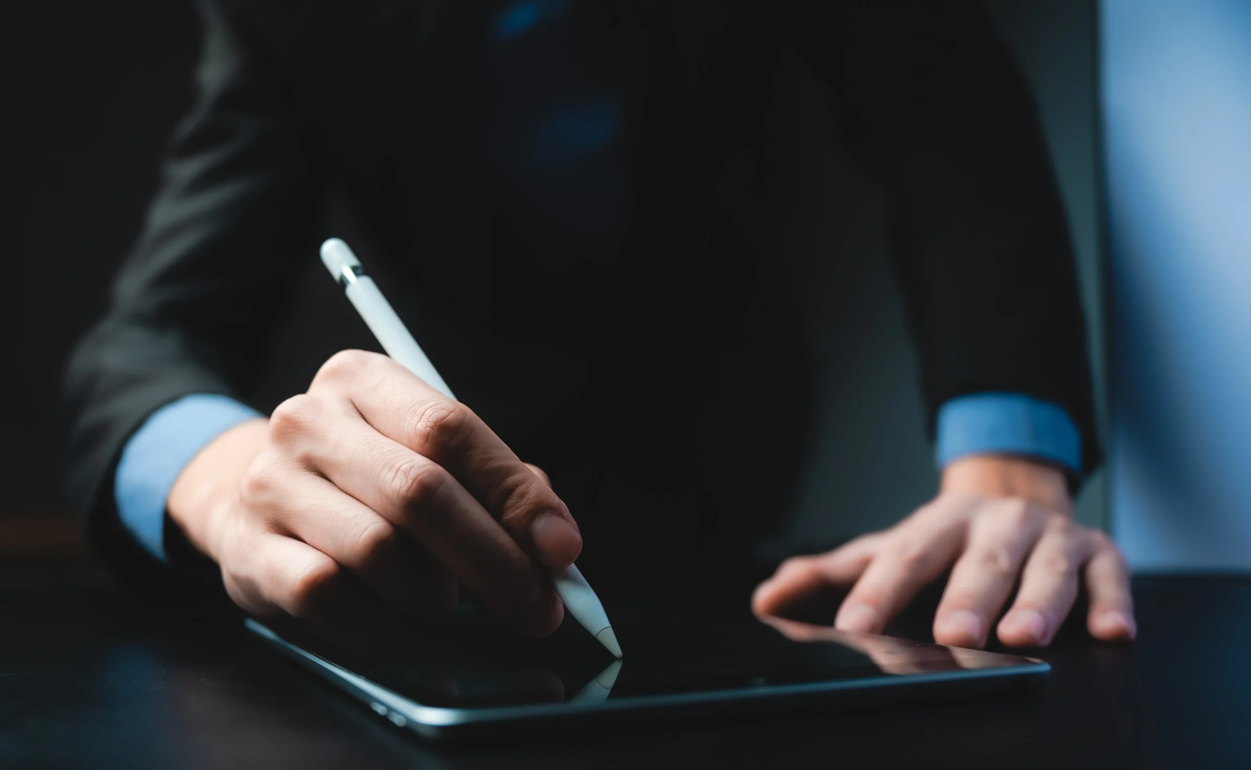 Business professional signing a digital document on a tablet using an e-signature pen — representing fast and secure online contract signing with SignBulb eSignature App.