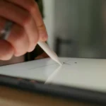 Close-up of a hand using a stylus to create online signature with electronic signature software on a tablet