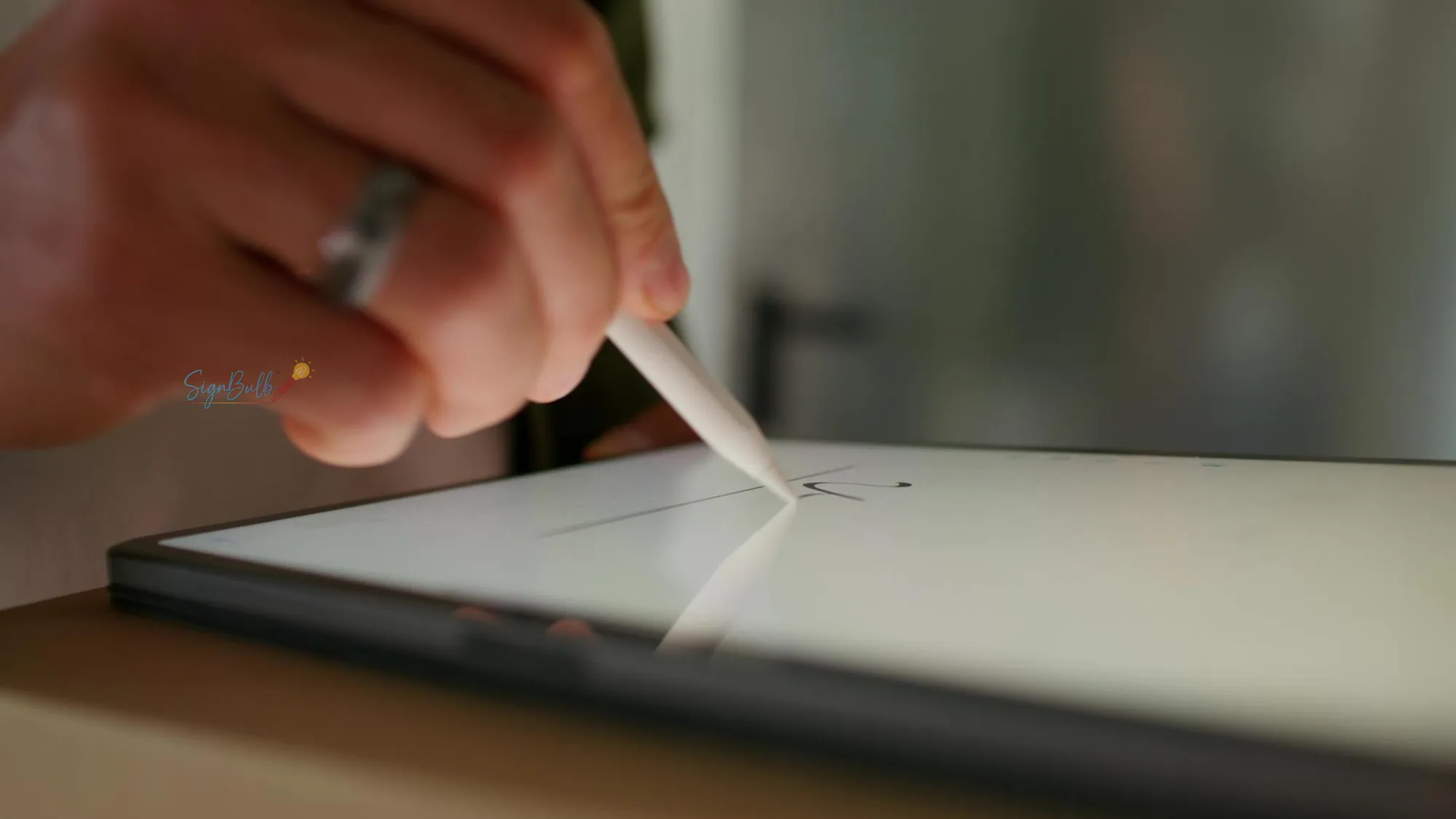 Close-up of a hand using a stylus to create online signature with electronic signature software on a tablet