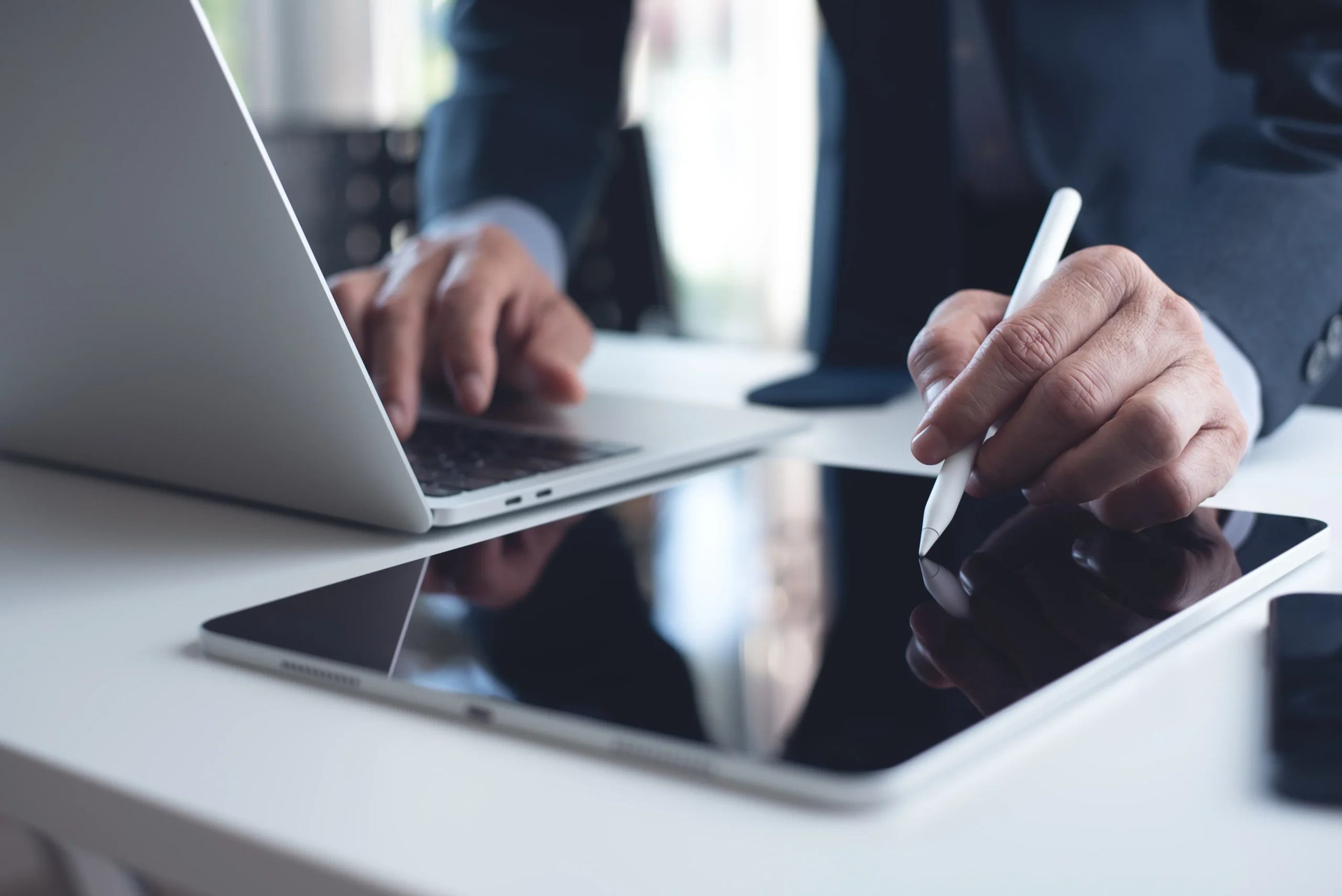 Professional signing a digital document on a tablet with a contract signing tool, demonstrating how to sign agreement online using a secure free contract e sign feature.