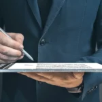Professional signing a digital document on a tablet with a contract signing tool, demonstrating how to sign agreement online using a secure free contract e sign feature.