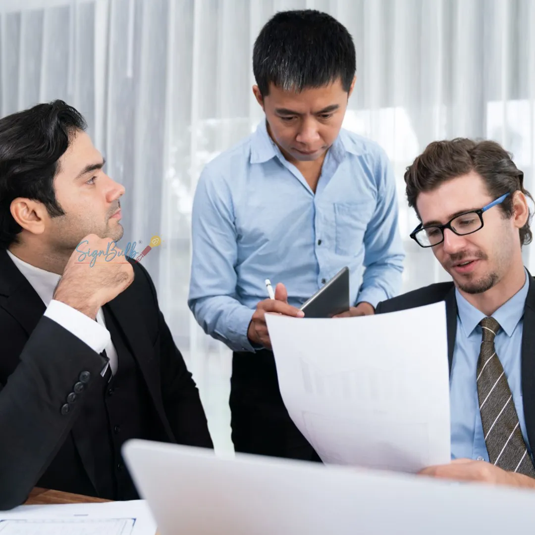 Business team reviewing documents and preparing to sign agreement online using a reliable contract signing tool with free contract e sign options for fast approvals.