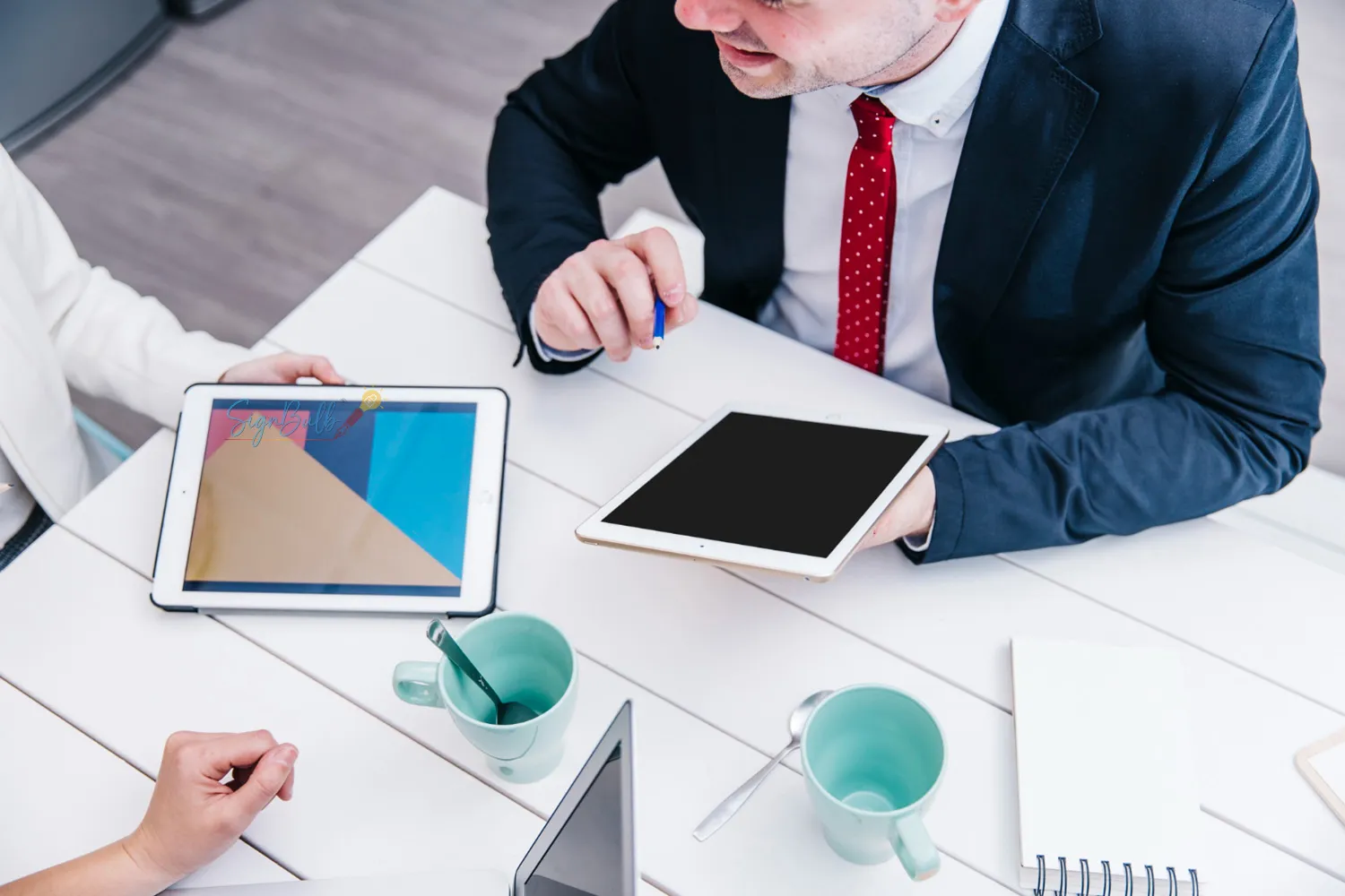 Business team reviewing reports and approvals using an e-signature tool and e-signature app as part of an eSignature partner program for SaaS and best SaaS affiliate programs.