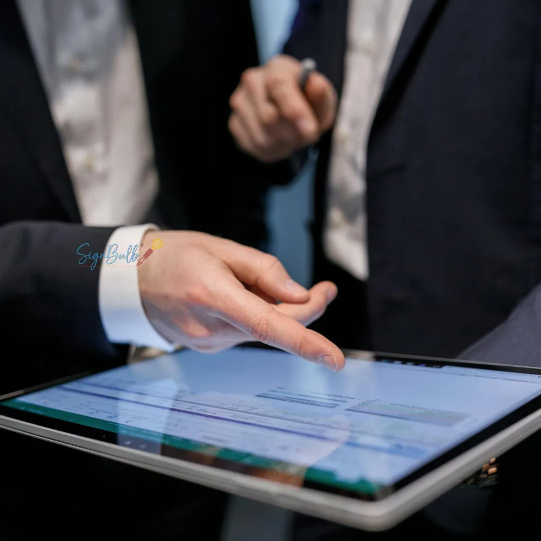 Executive reviewing a contract on a tablet with a digital signature interface, reflecting eSignature Market Growth and secure approvals.