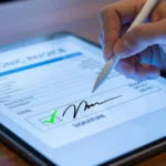 Person using a digital pen tablet with e signature software and e signature tools for secure document signing software in business workflow.