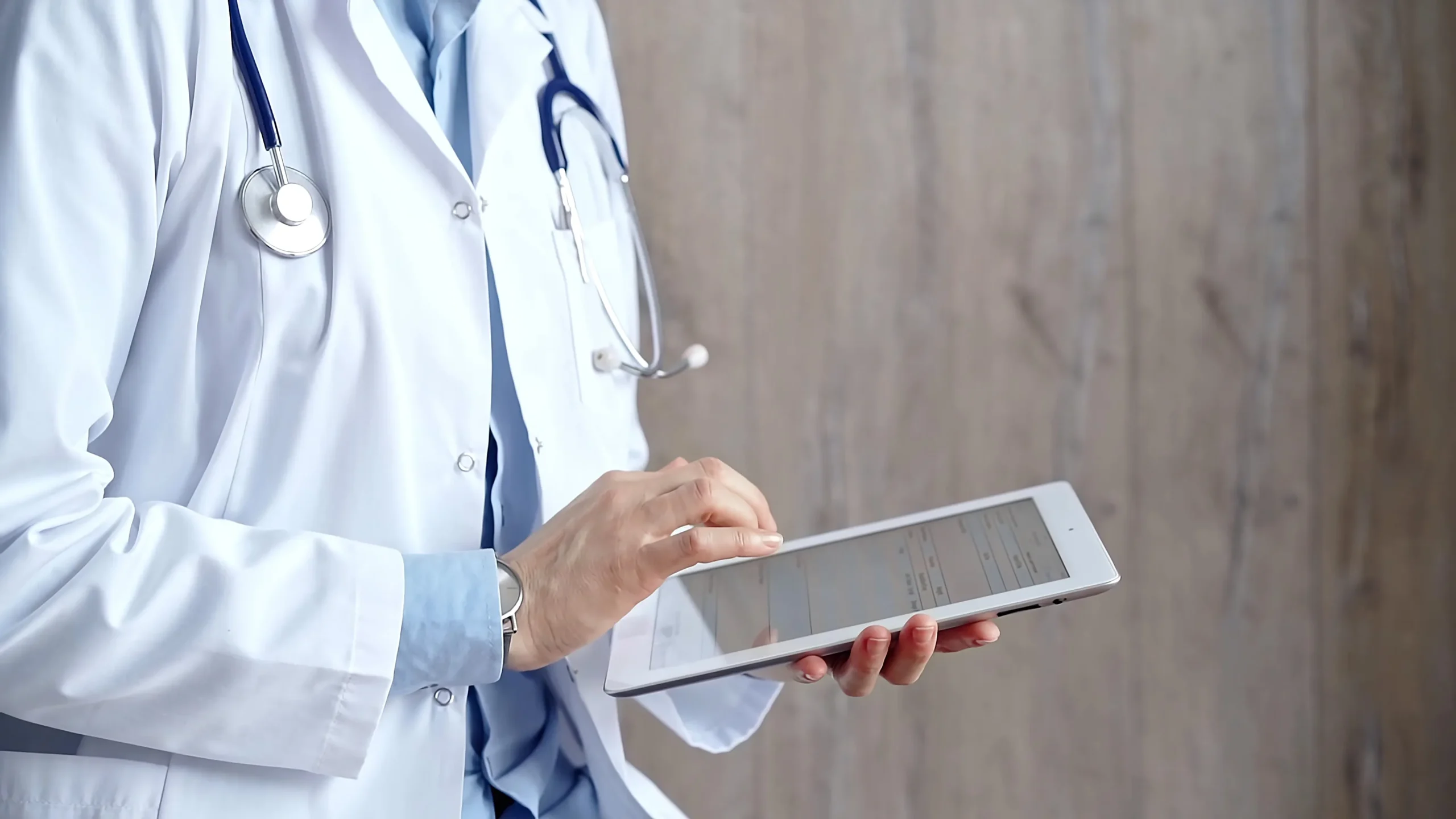 Doctor holding tablet for electronic signature software for healthcare, supporting secure patient forms and approvals.