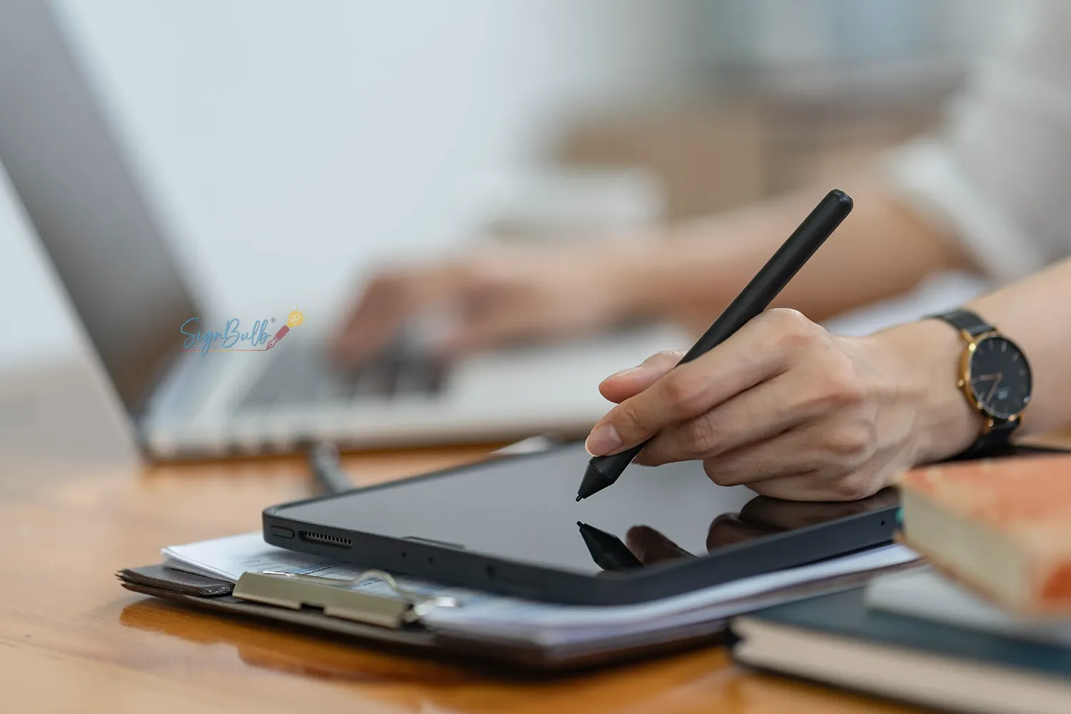 Business professional signing digital contract using SignBulb eSignature platform in modern office environment.