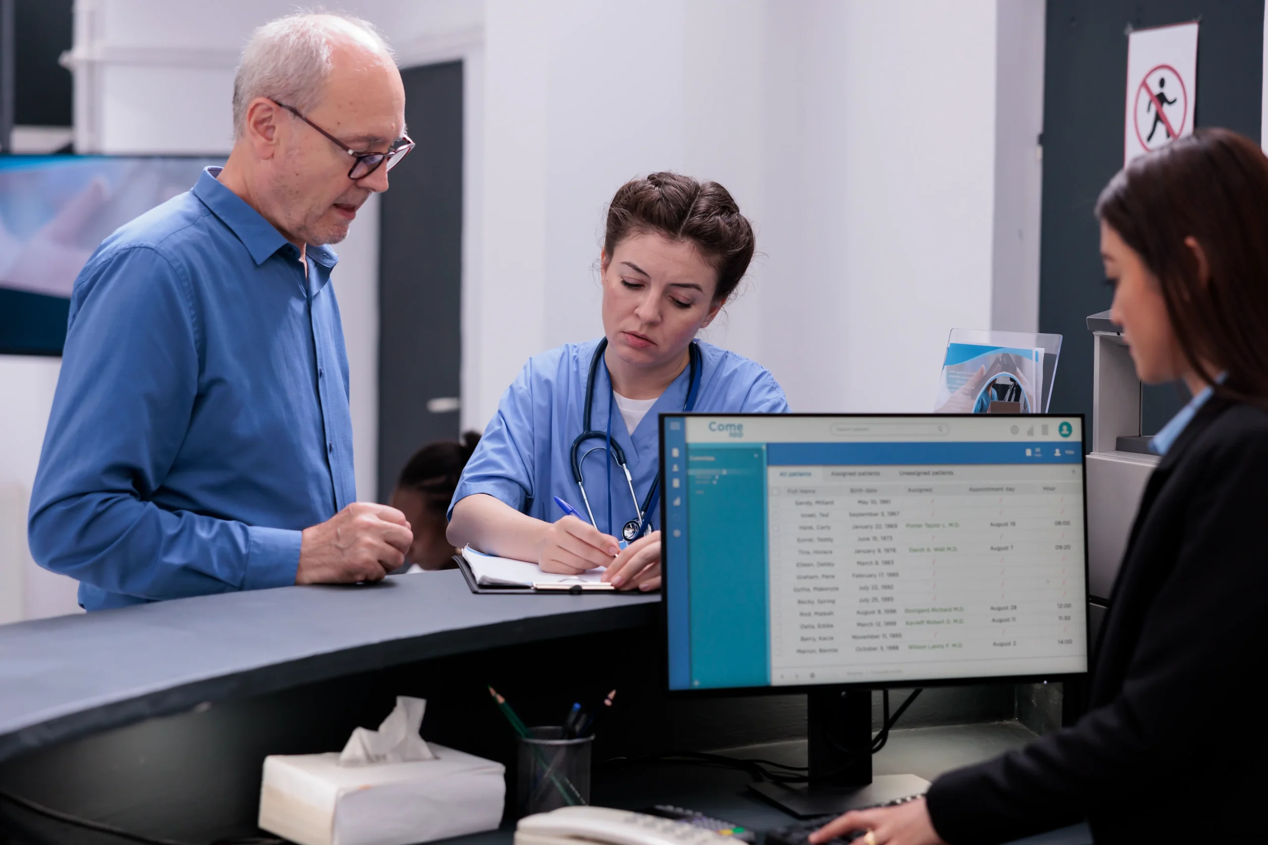  Front desk staff using healthcare eSignature software, showing Benefits of eSignature in healthcare with faster check-in for providers.