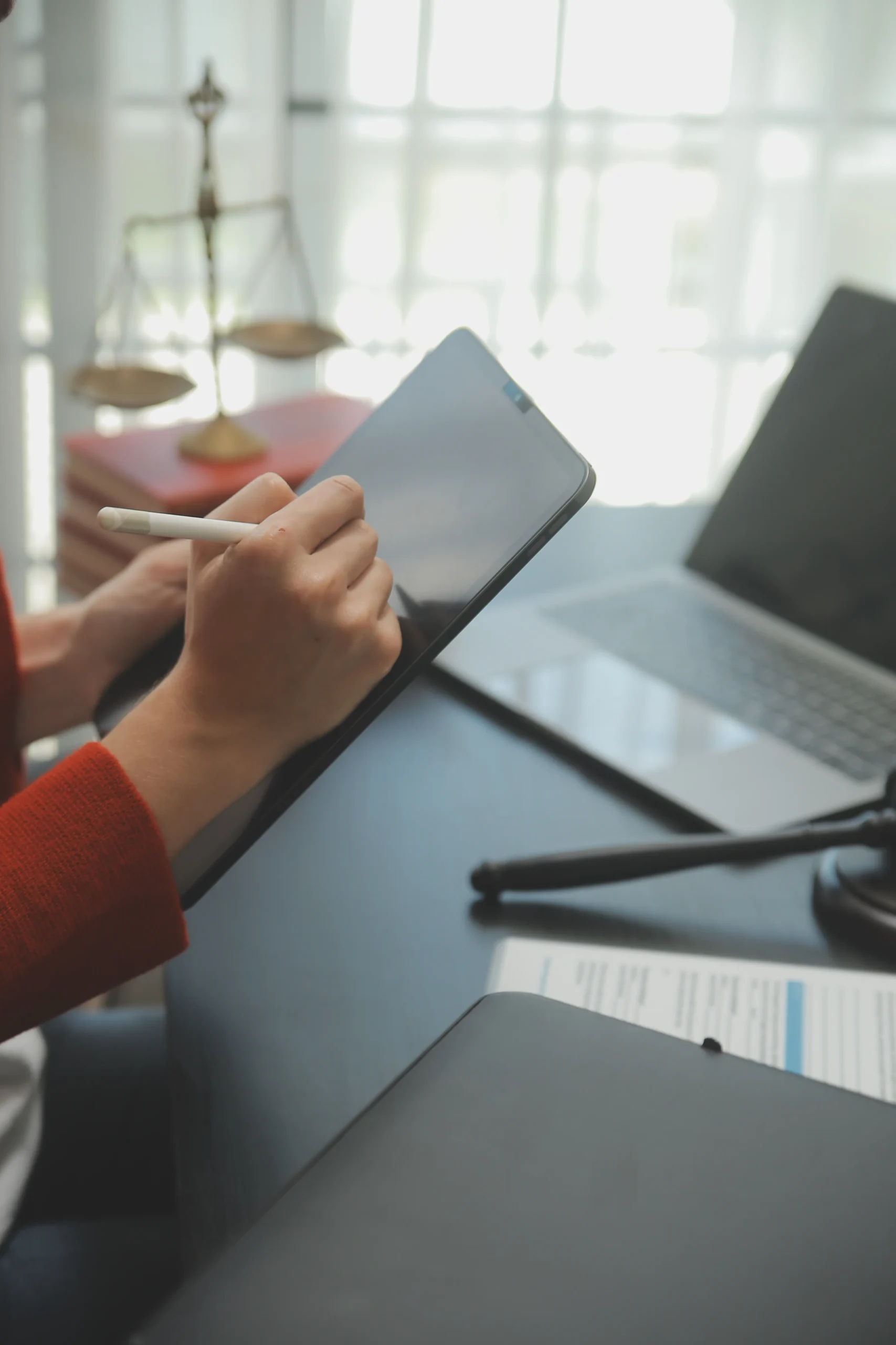 A remote worker signs on a tablet, using a digital signature app and e-signature software to complete documents securely.