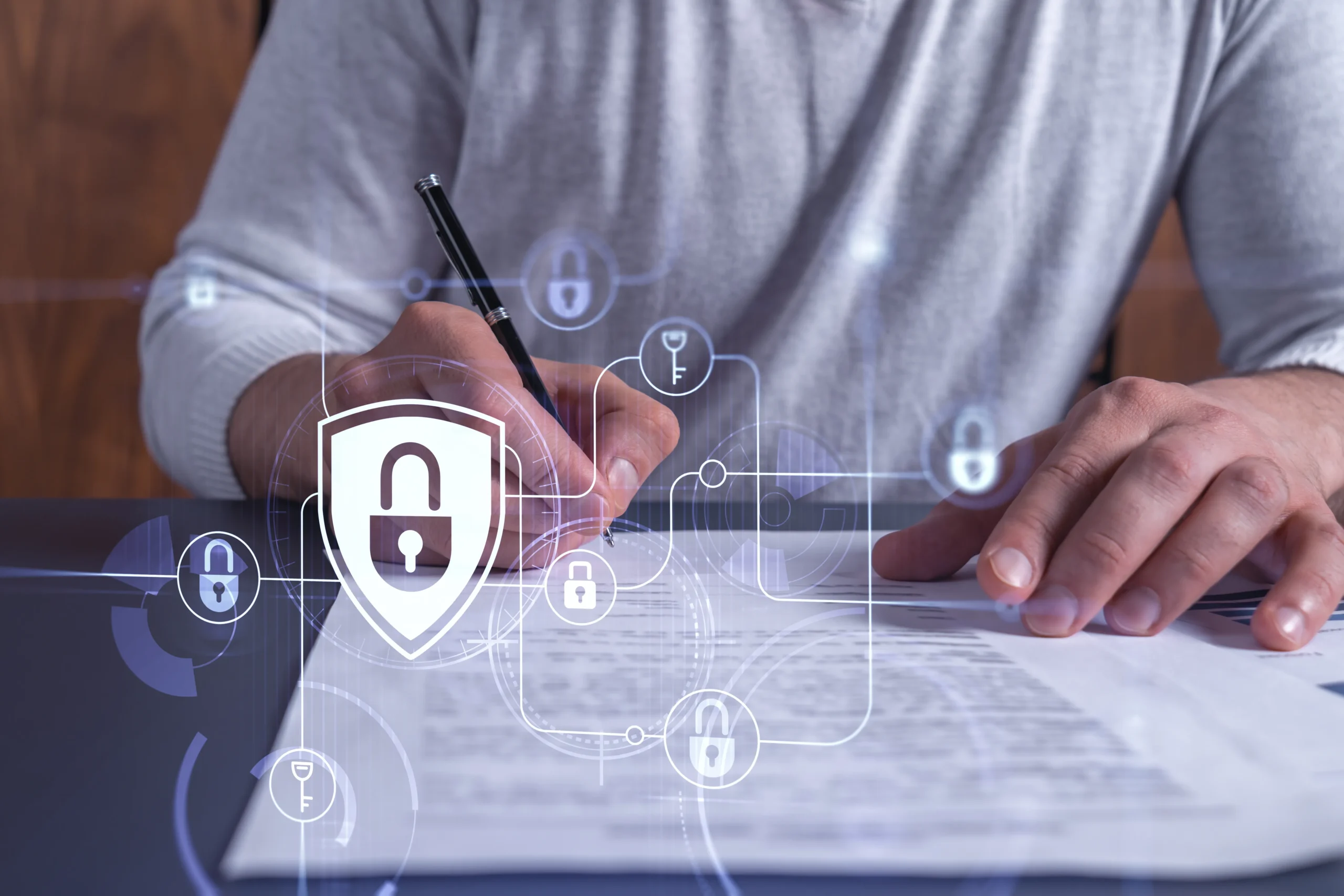 Person signing a document overlaid with digital lock icons, illustrating eSignature security and electronic signature compliance.