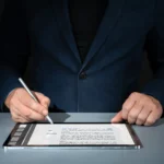 Businessman using a stylus on a tablet for digital contract signing to close deals faster.