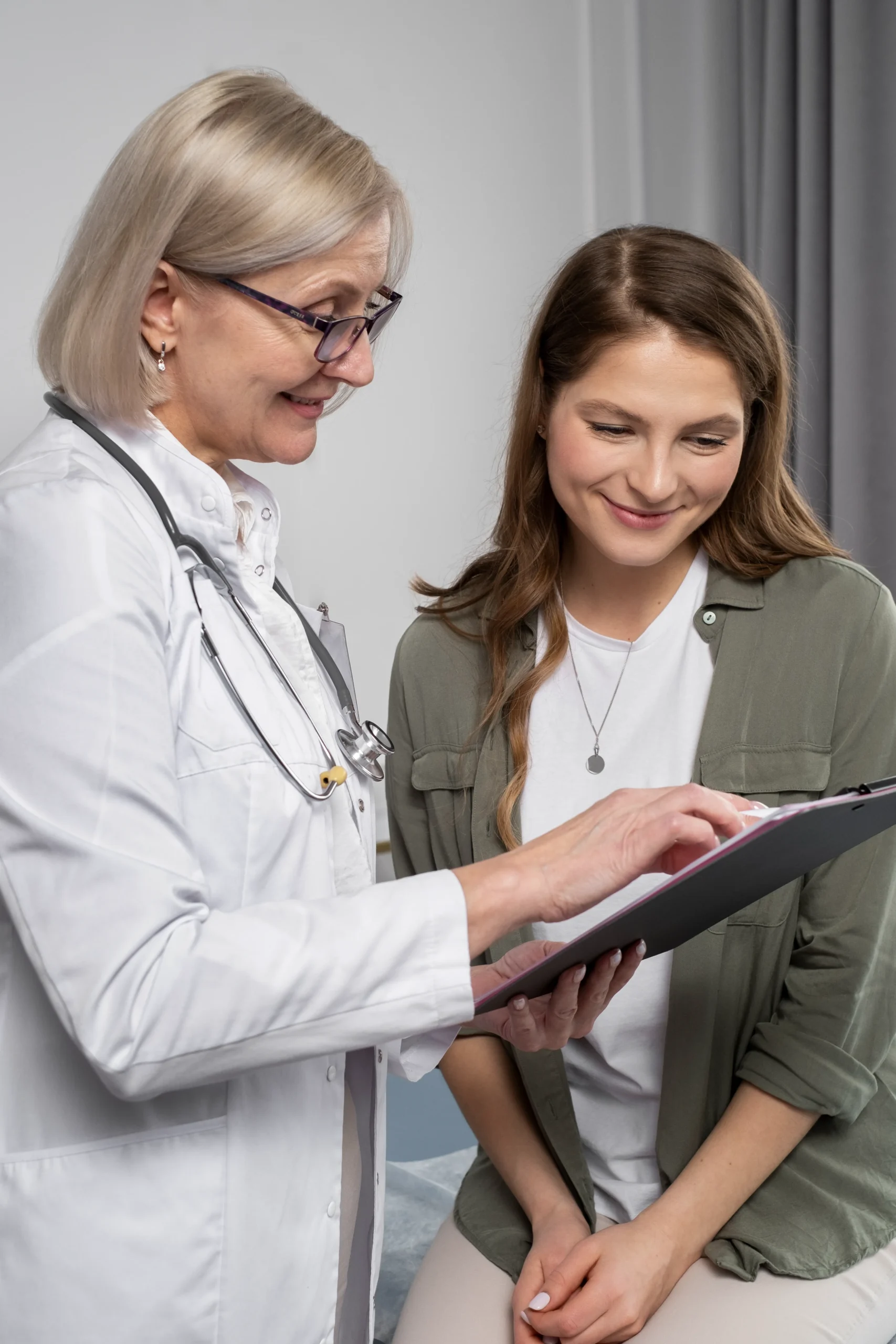 A friendly female doctor standing and talking with a patient, establishing trust for online document signing.