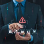 A professional working on a laptop with financial documents, using a secure eSignature for finance to complete transactions.