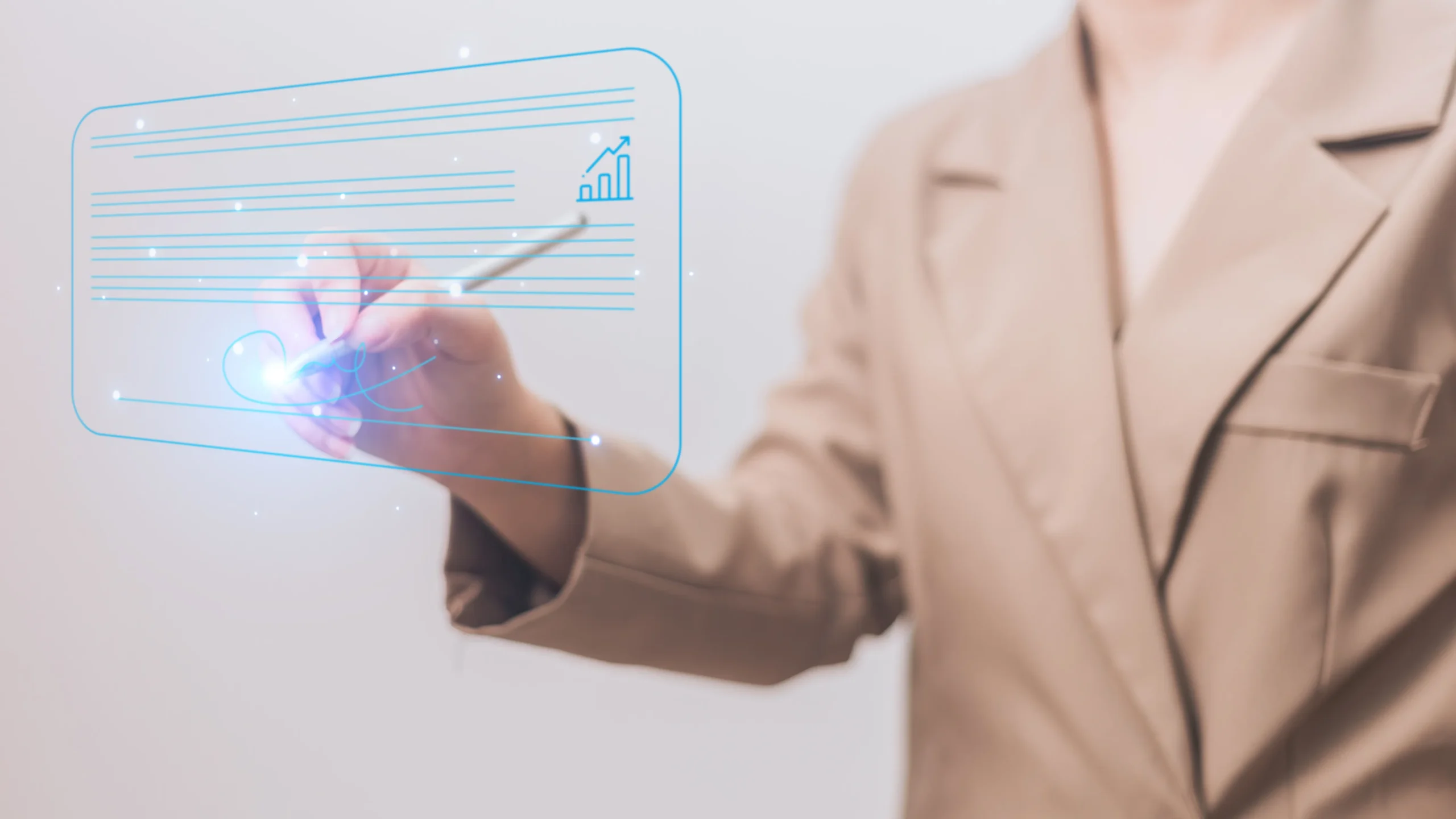 A professional in a beige suit using a stylus pen to write on a glowing digital interface, demonstrating the seamless workflow of modern e signature tools.