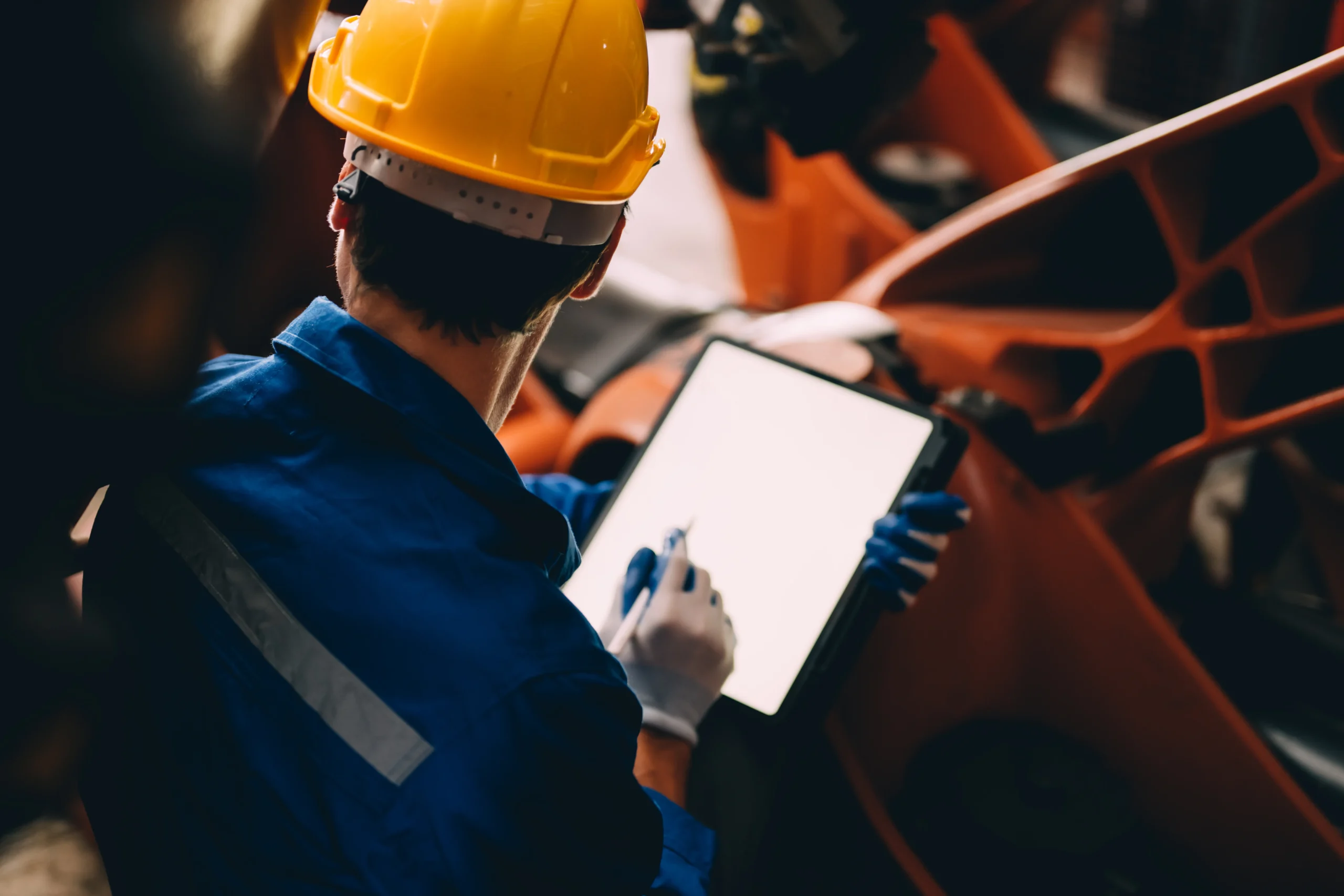 Worker uses a digital signature app for an electronic signature for manufacturing.