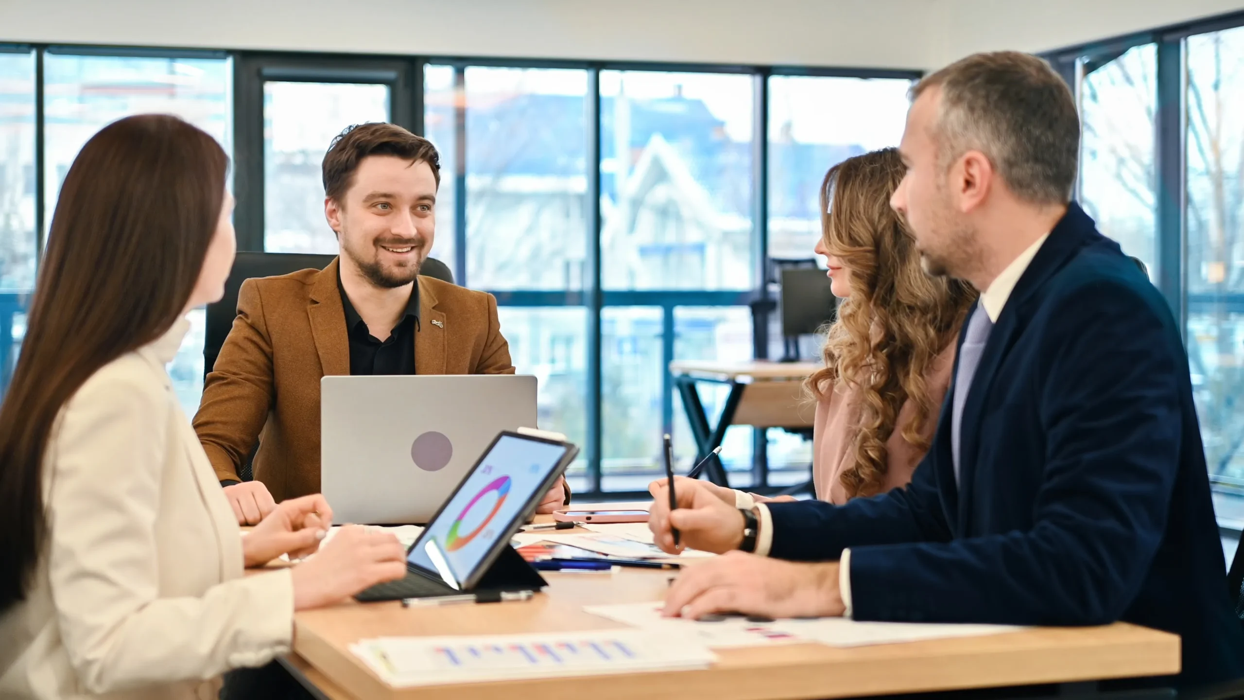Business team discussing procurement documents using a secure eSignature platform on a tablet.
