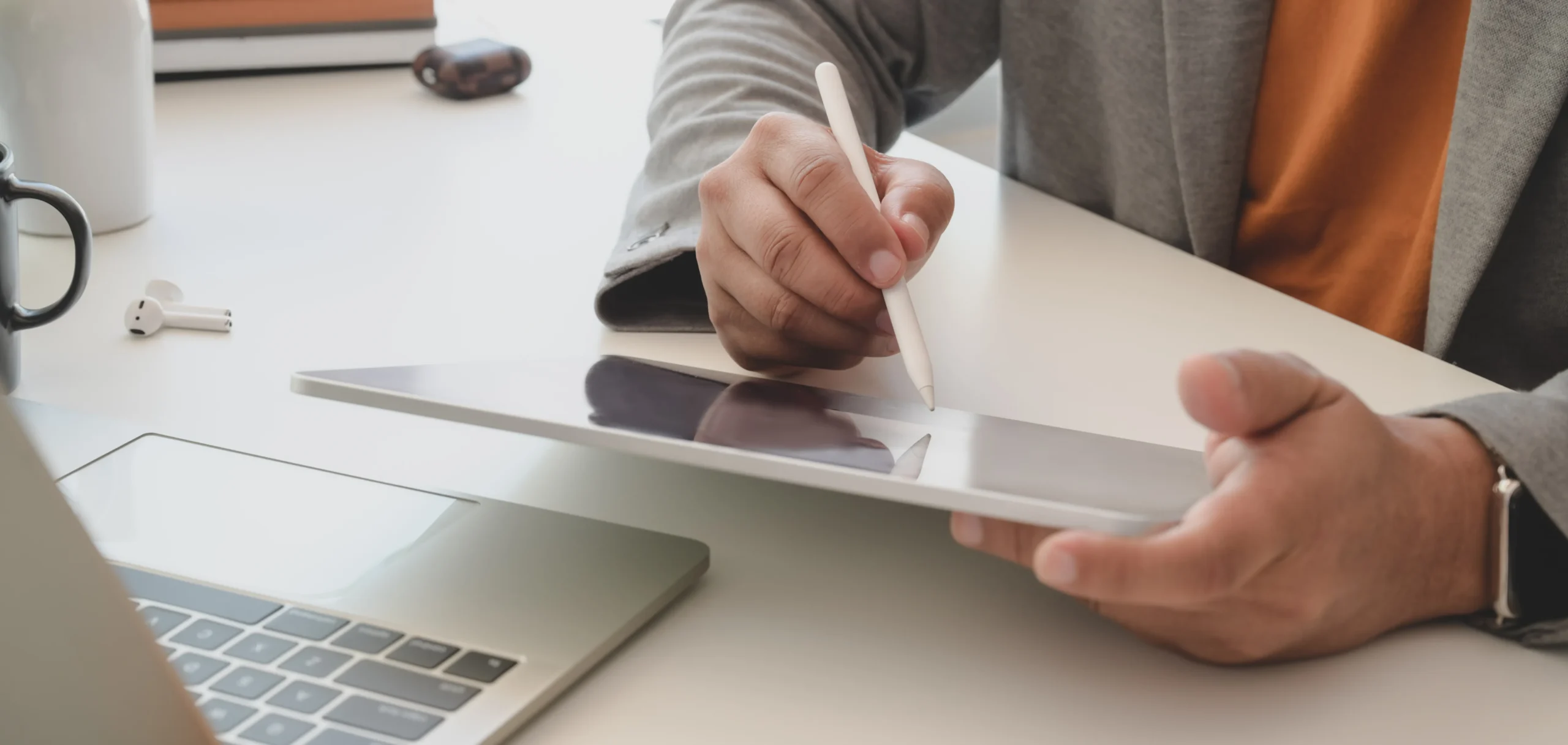 Professional filling out digital forms on a tablet using a modern esignature app.