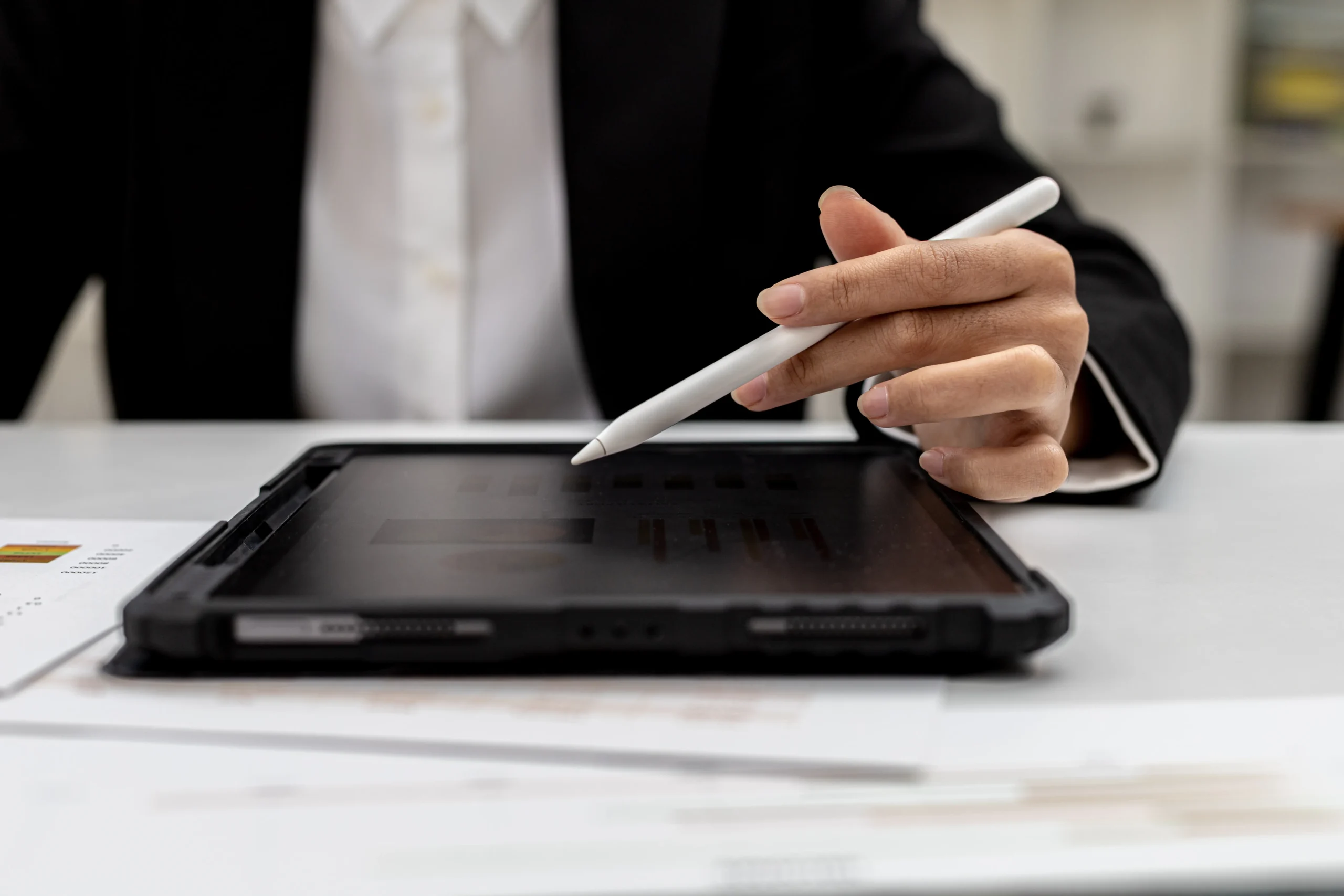 Business professional reviewing digital documents and budget details for eSignature pricing comparison.