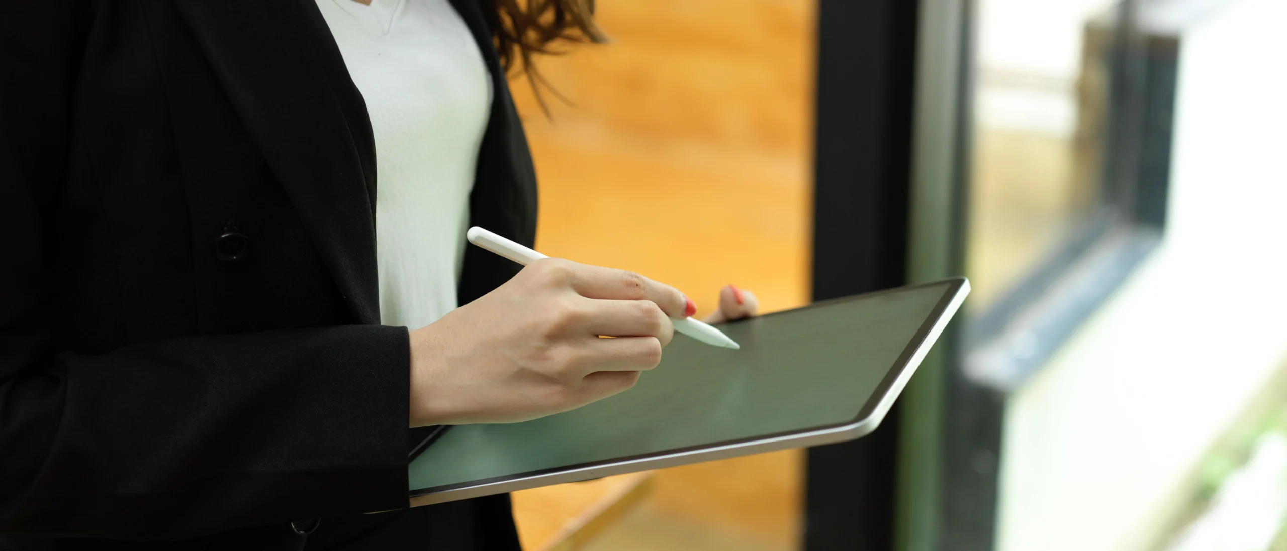 Business professional capturing a digital signature on a tablet using an electronic signature API.