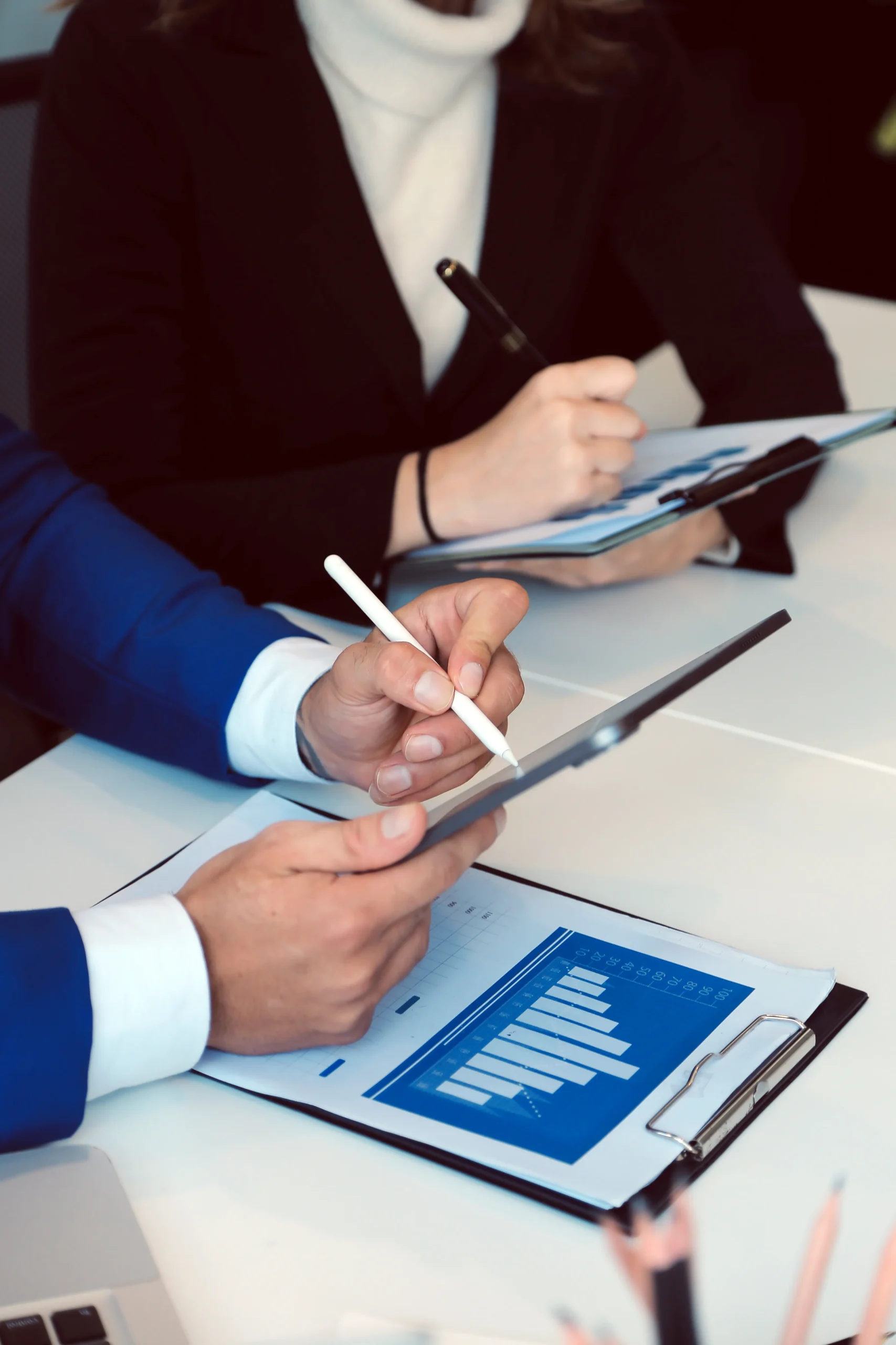 Professional using a stylus to sign procurement contracts on a tablet with a secure eSignature platform.