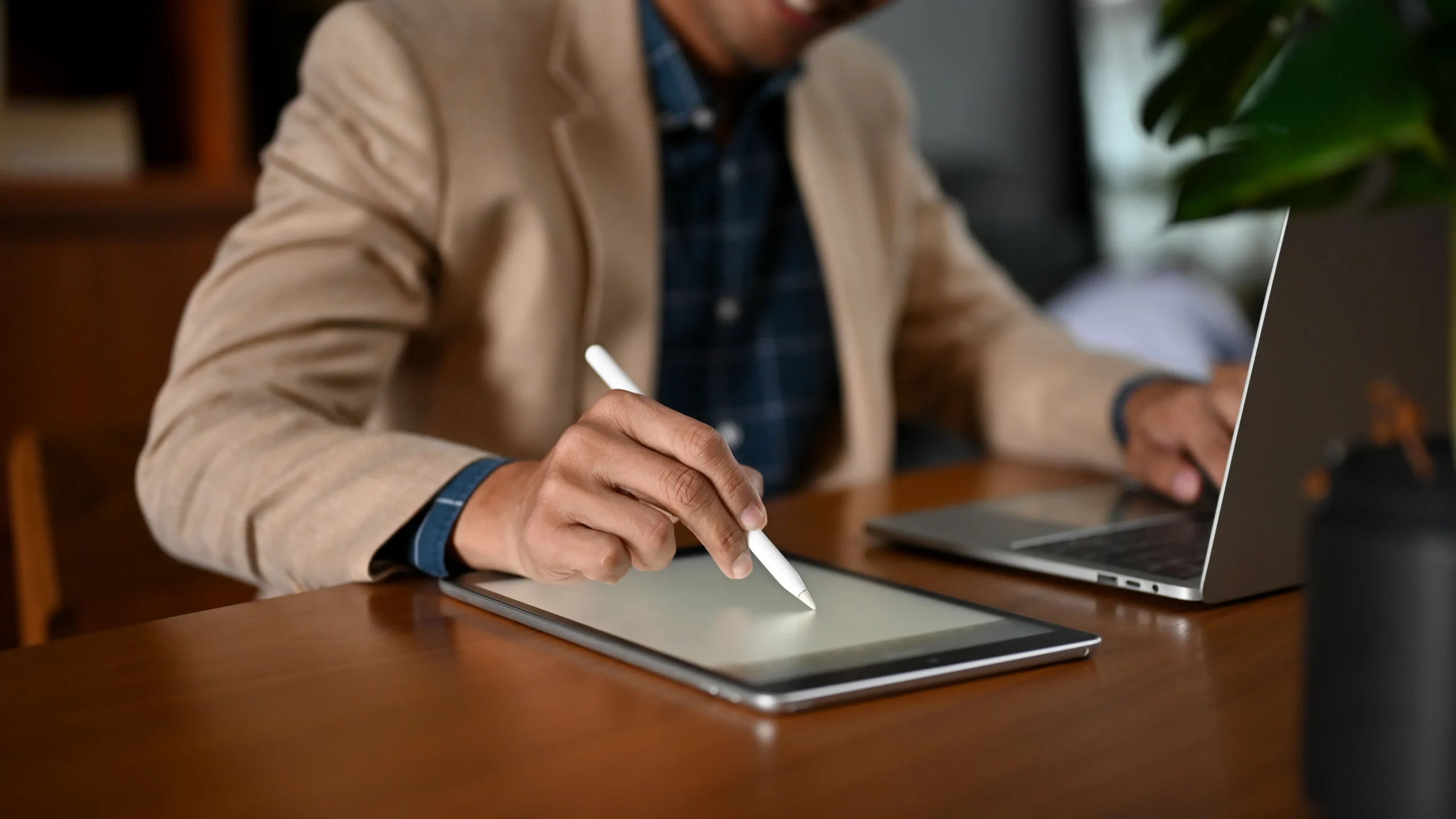Startup founder drawing a signature on a tablet screen using esignature software for startups.