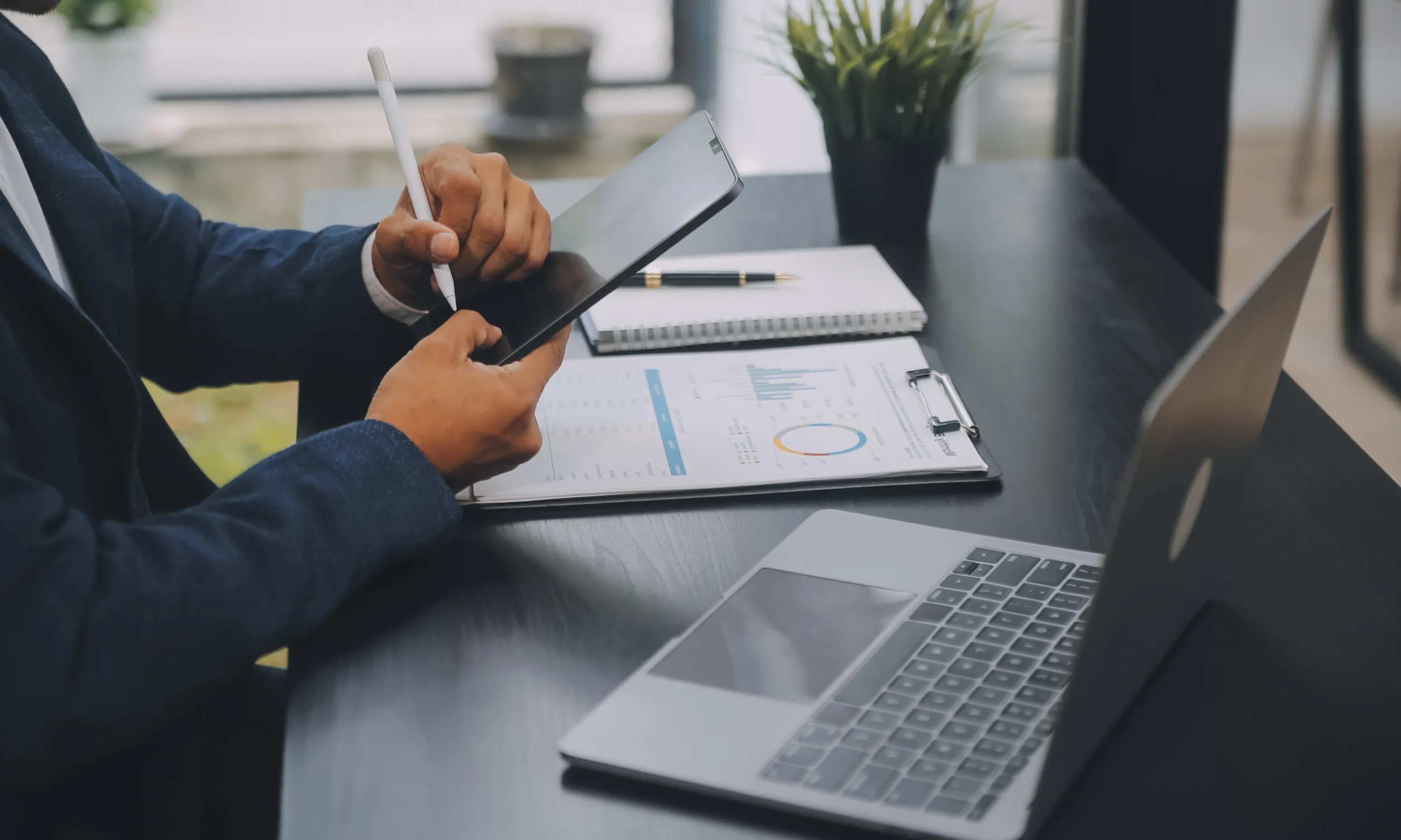 Professional completing mobile document signing using a stylus on a digital tablet.
