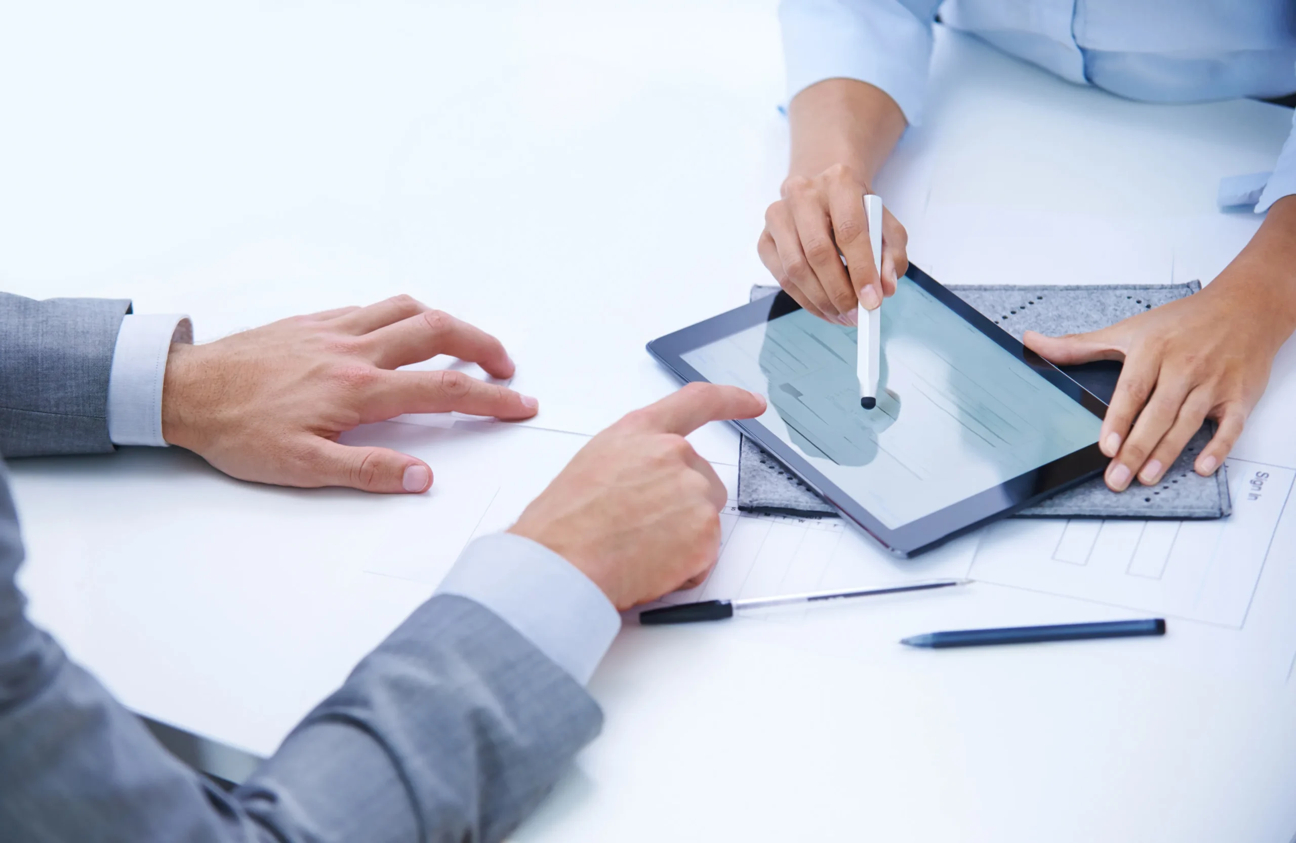 Client using a stylus on a tablet screen to complete digital signing via a scalable eSignature platform.
