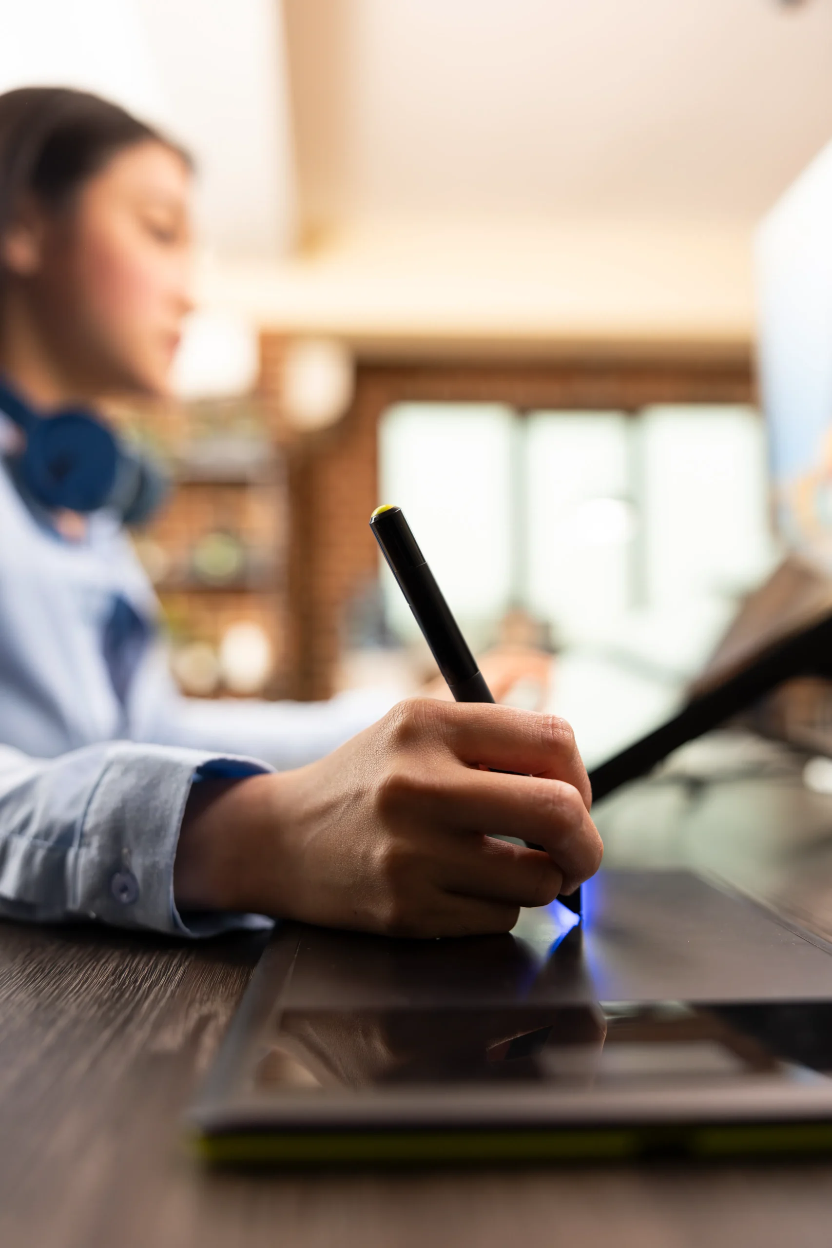 User applying a digital signature on a drawing tablet using document management and eSignature software.