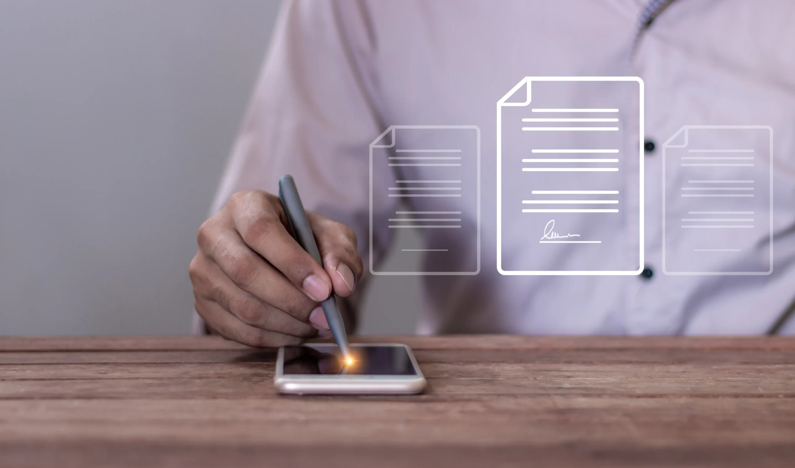 Person using a stylus to sign contract on phone using floating document verification overlays.