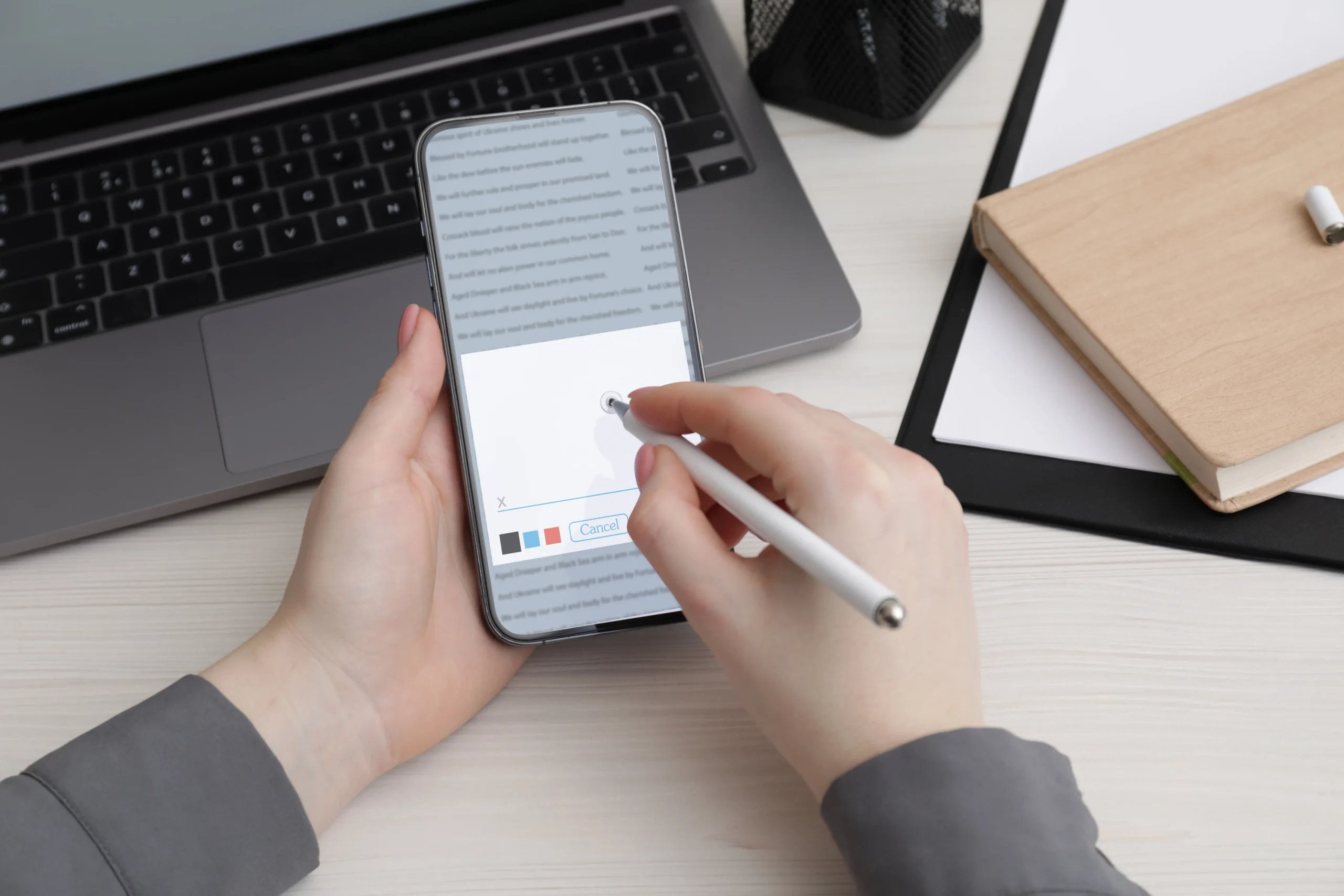 User drawing a digital signature with a stylus to sign pdf on iphone.