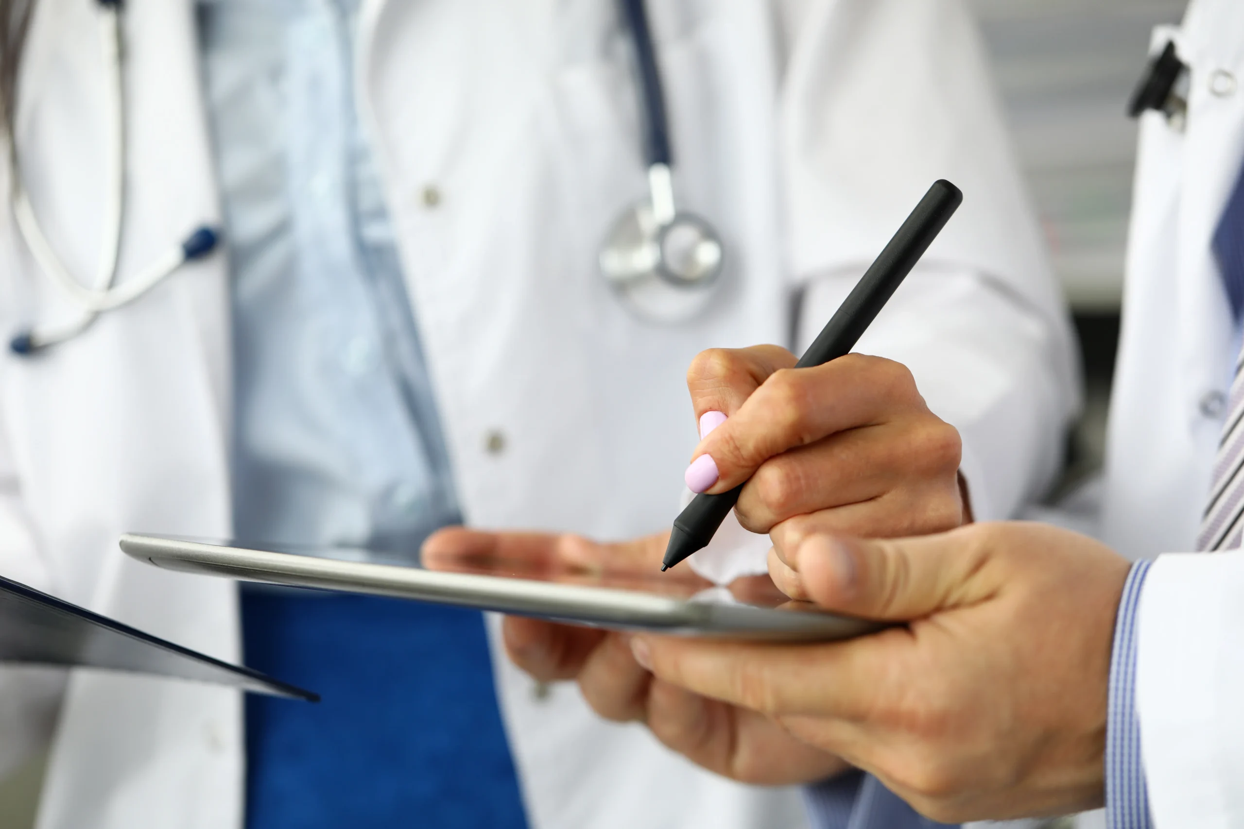 Medical staff executing a HIPAA-compliant healthcare eSignature on a tablet screen.