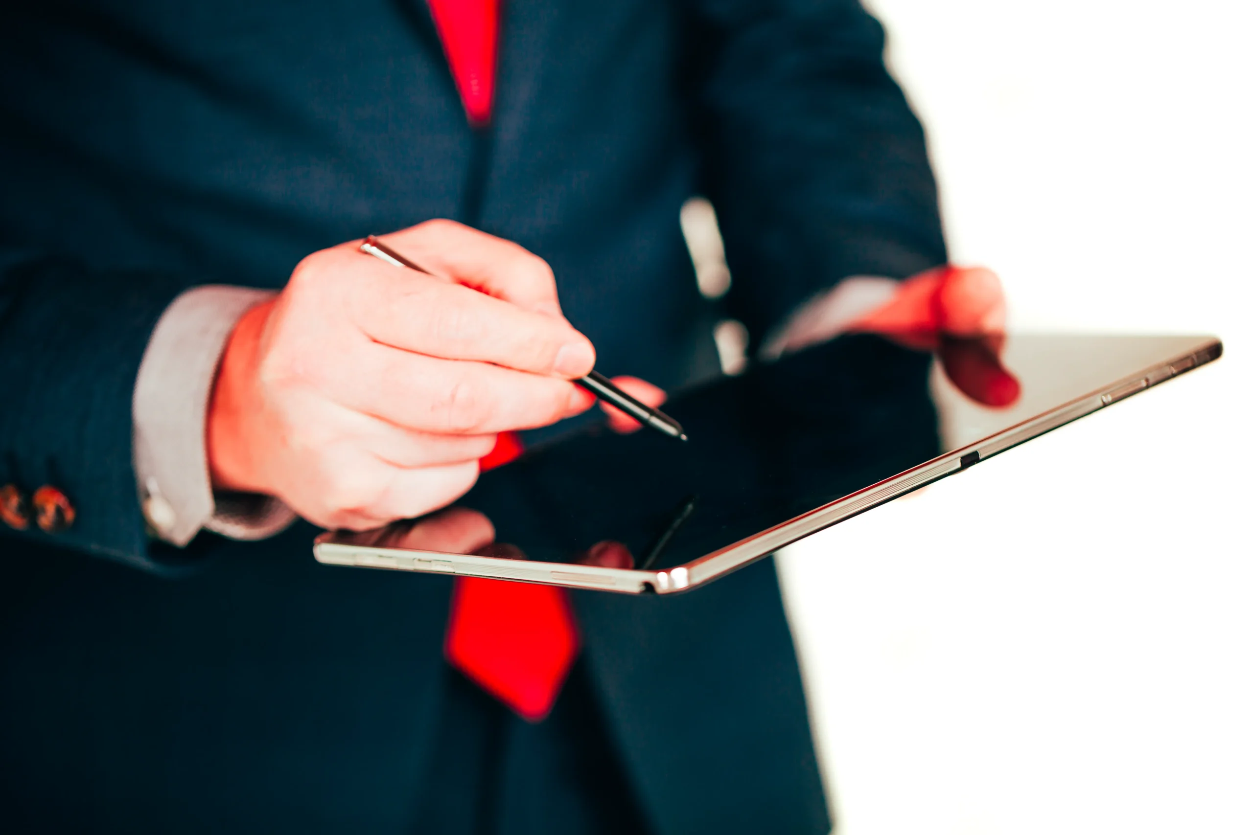 Businessman holding a tablet device to capture digital authorization via an electronic signature API.