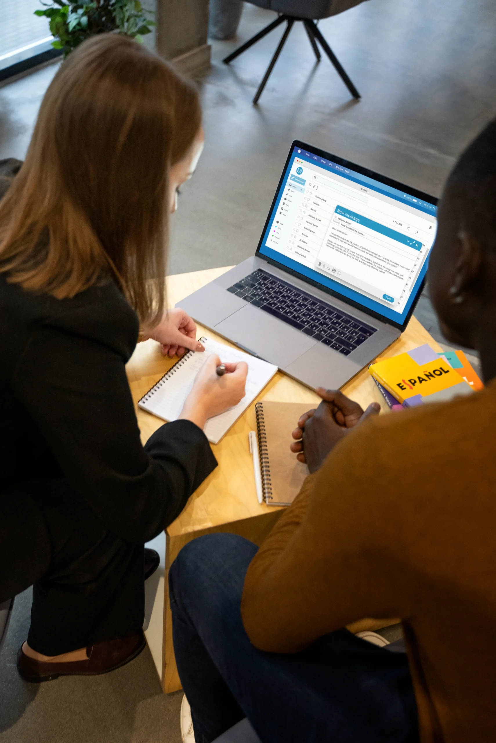 Two business partners reviewing contract terms on a laptop to finalize an nda template.