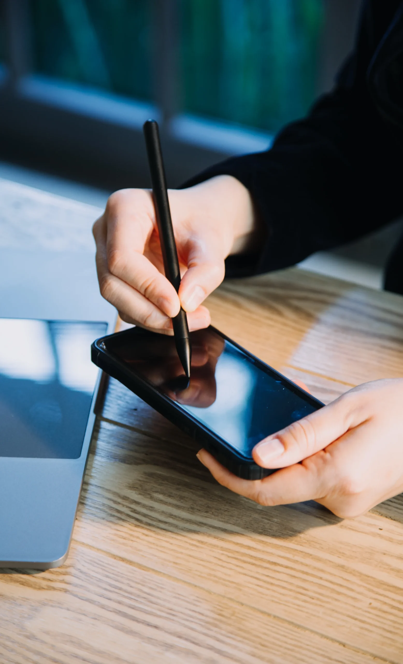 Close-up of user applying digital stylus signature to sign documents on phone.